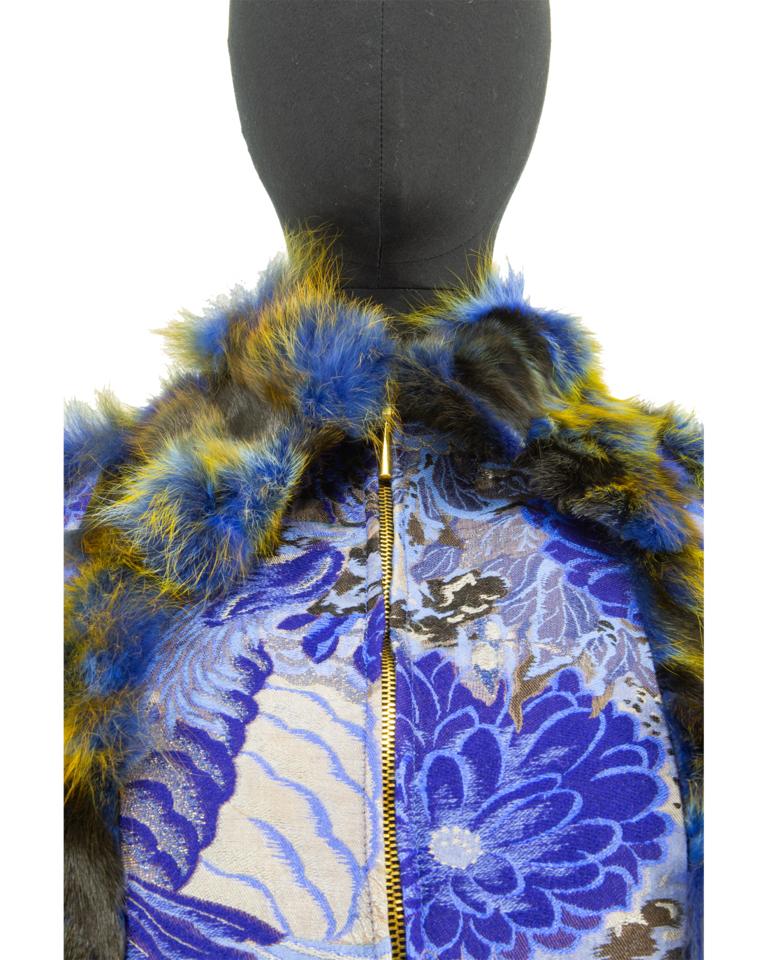 Highly sought after voyage jacket in a Japanese inspired brocade design, in shades of blue and gold with lurex threads that add a shimmer in places. It has complimenting fox fur collar, cuffs and hem as well as strategic seams to give the feeling of