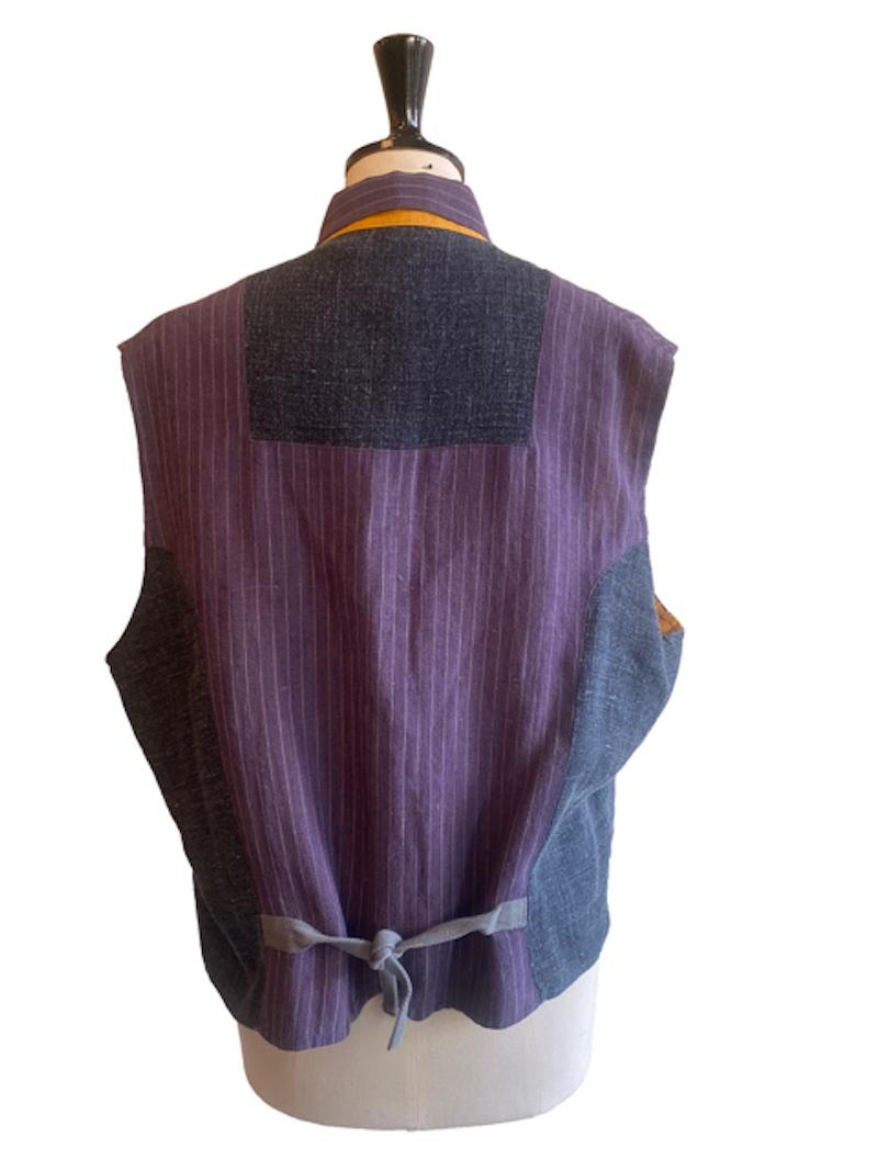 Vintage linen waistcoat from Voyage England. Purple pinstripe linen upper with contrast mustard yellow flap over pockets either side of the waist. Fully lined in mustard linen. Made in England. Marked size Large. Measurements: Chest: 60cm.