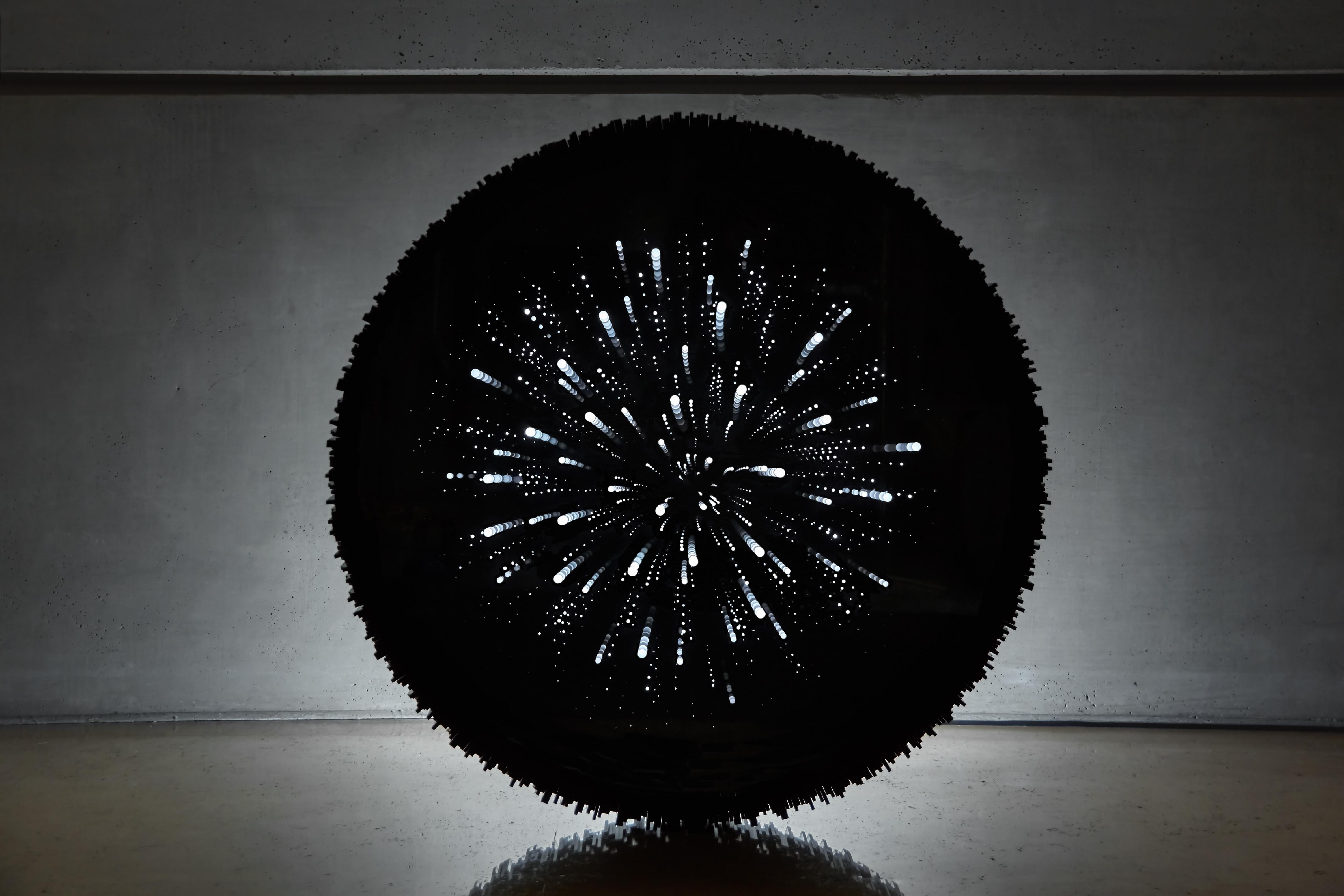 Voyage Spatial by Abdo el Moudawar
Materials: Black Acrylic frame structure covered with around 600 pcs of 4mm thick black acrylic 
 Mirrored dark glass for the front.
 Black acrylic back cover.
 Concealed mirrors 
 Warm white LED lights.
