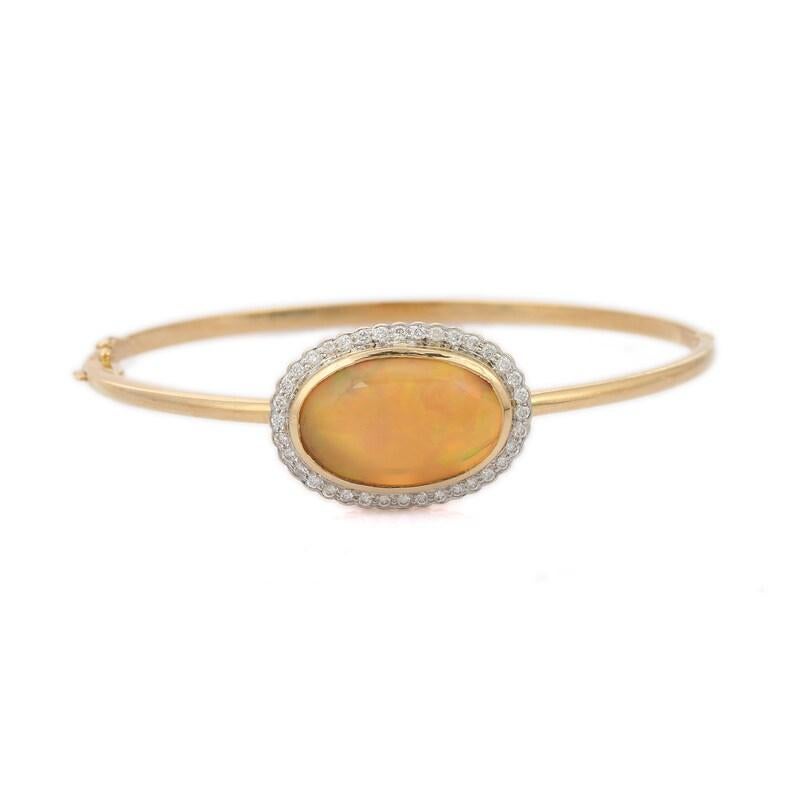 Opal and Halo Diamond Bangle Bracelet in 18K Gold. It’s a great jewelry ornament to wear on occasions and at the same time works as a wonderful gift for your loved ones.
Opal enhances creativity, passion and strength.
These lovely statement pieces