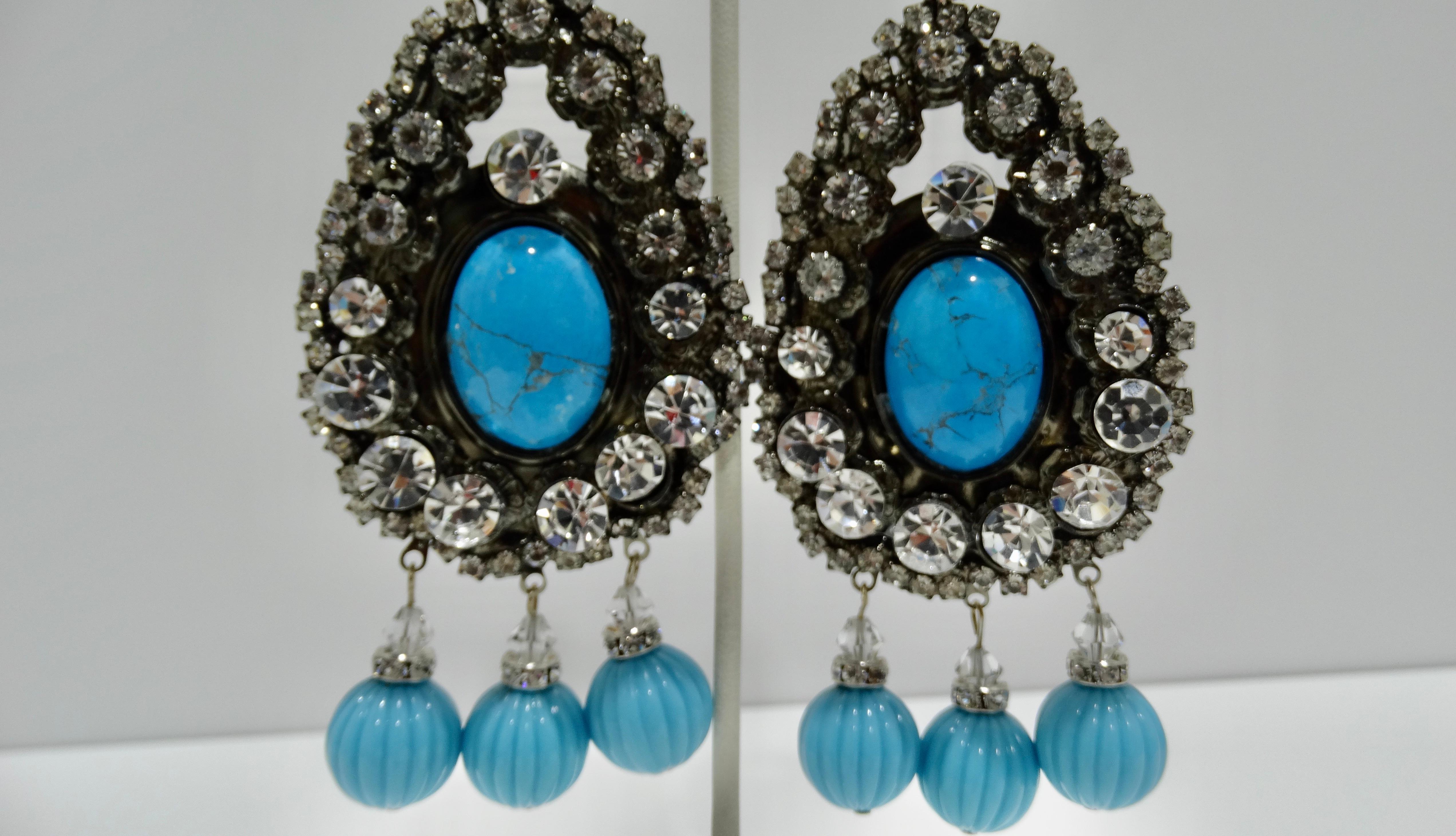 These huge Lawrence VRBA earrings are a rare find. Look no further for a one-of-a-kind statement earring to wear to your next event. Dozens of clear crystals surround a large turquoise stone and drop details add a sense of elegance. Don't blend in