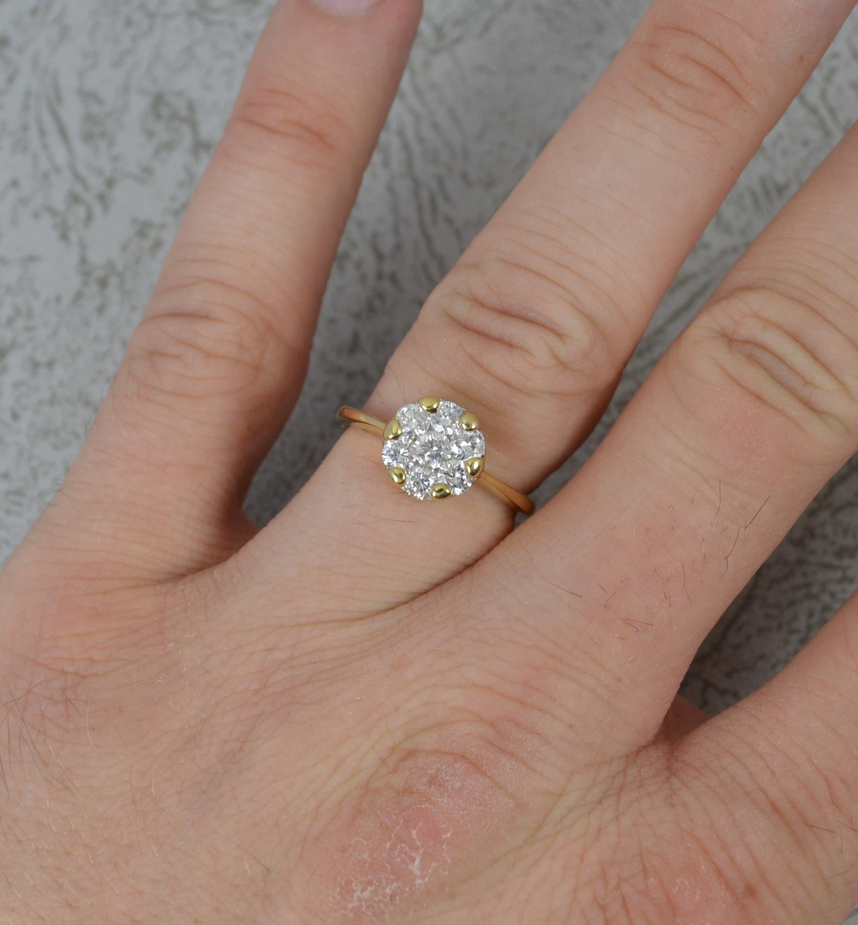 A superb contemporary diamond cluster ring.
Solid 18 carat yellow gold example.
The circular cluster head, 8.8mm diameter, set with seven round brilliant cut diamonds to total 0.75cts. Vs clarity. Protruding 4.5mm off the finger.

CONDITION ;