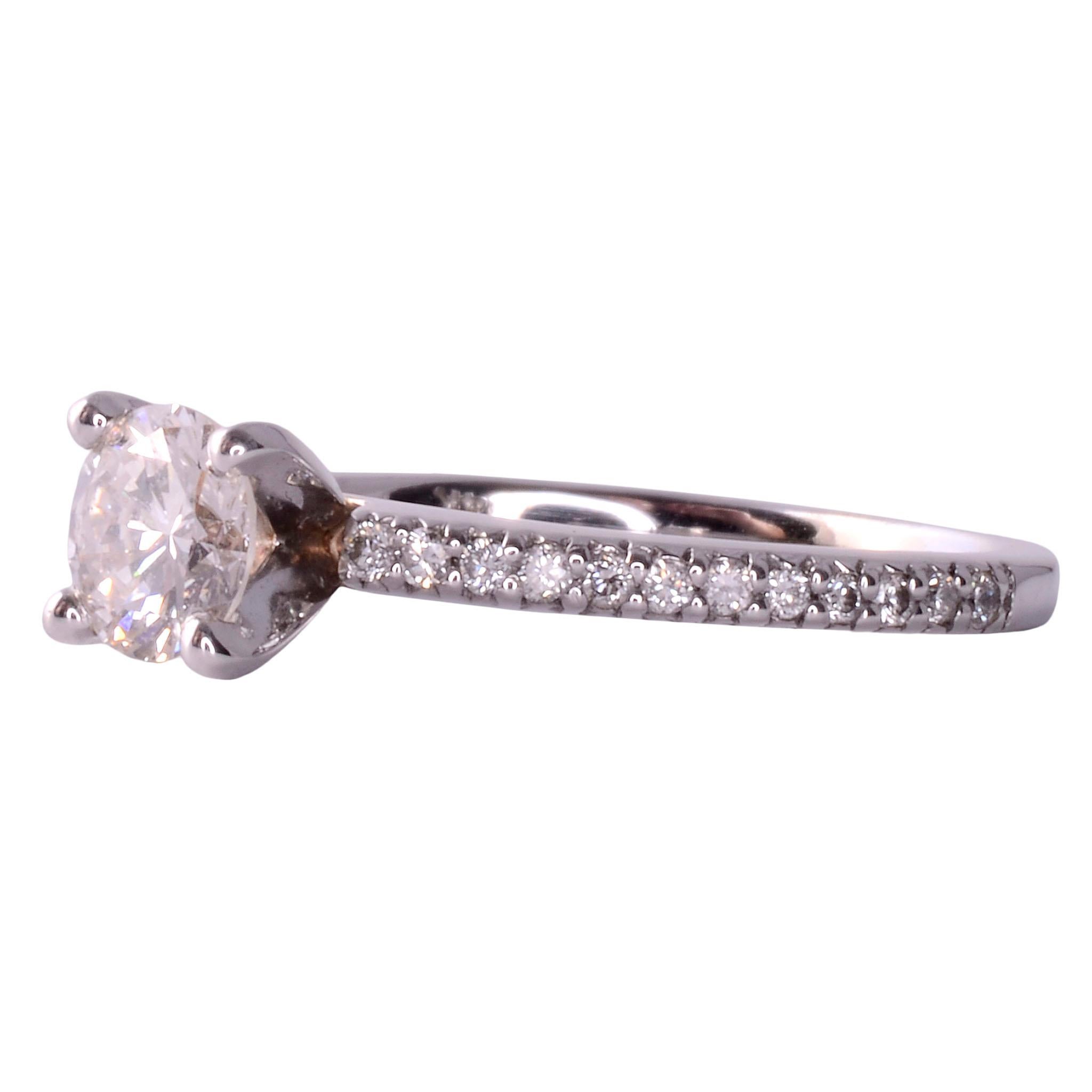 Estate VS diamond engagement ring. This 14 karat white gold engagement ring features a VS1 diamond center at .53 carat with K color. The diamond has a very good cut grade and is accented with 24 full cut diamonds on the band at .25 carat total