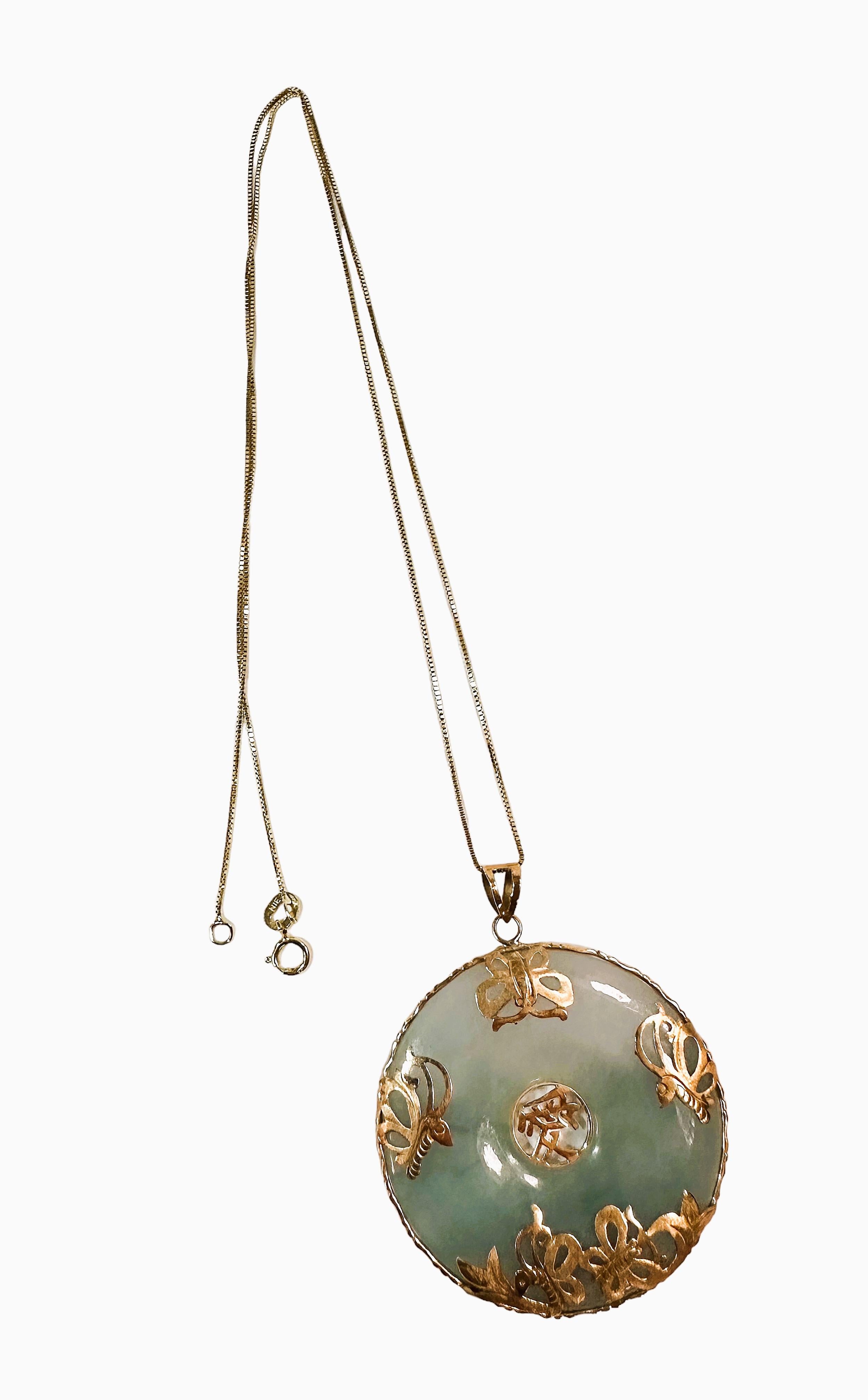 This is a fabulous pendant necklace.  The chain is 14k Gold and stamped and the pendant is Jade and 14K gold and is also stamped. The pendant without the bail is 1.5 inches round. The chain is 18 inches long.   It is pre-owned and  in excellent