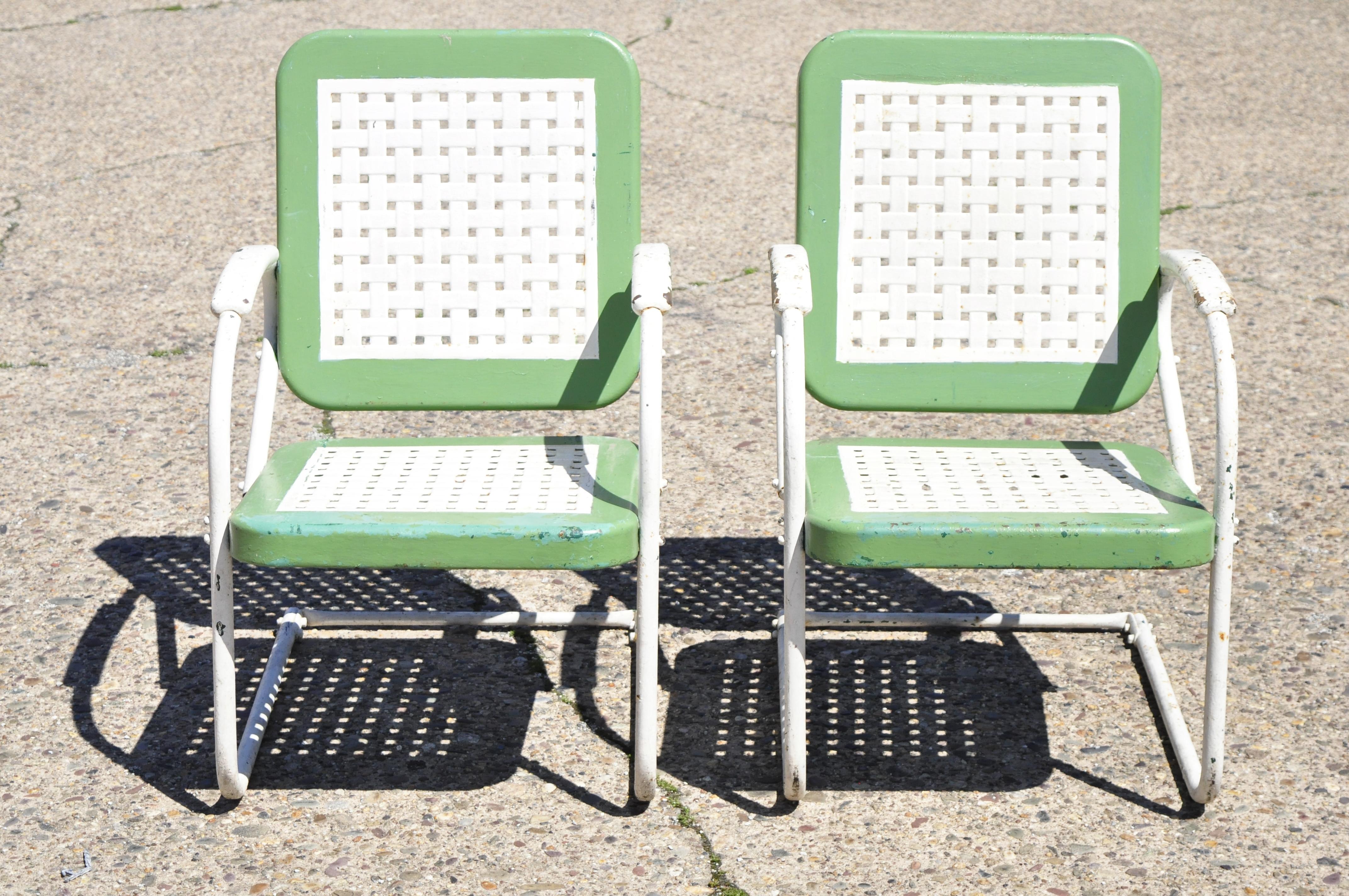 Vintage Art Deco metal basketweave old green porch outdoor spring arm chairs - pair. Item features original green and white painted finish, woven basket weave seat and back, metal frames, very nice antique chairs, quality American craftsmanship,