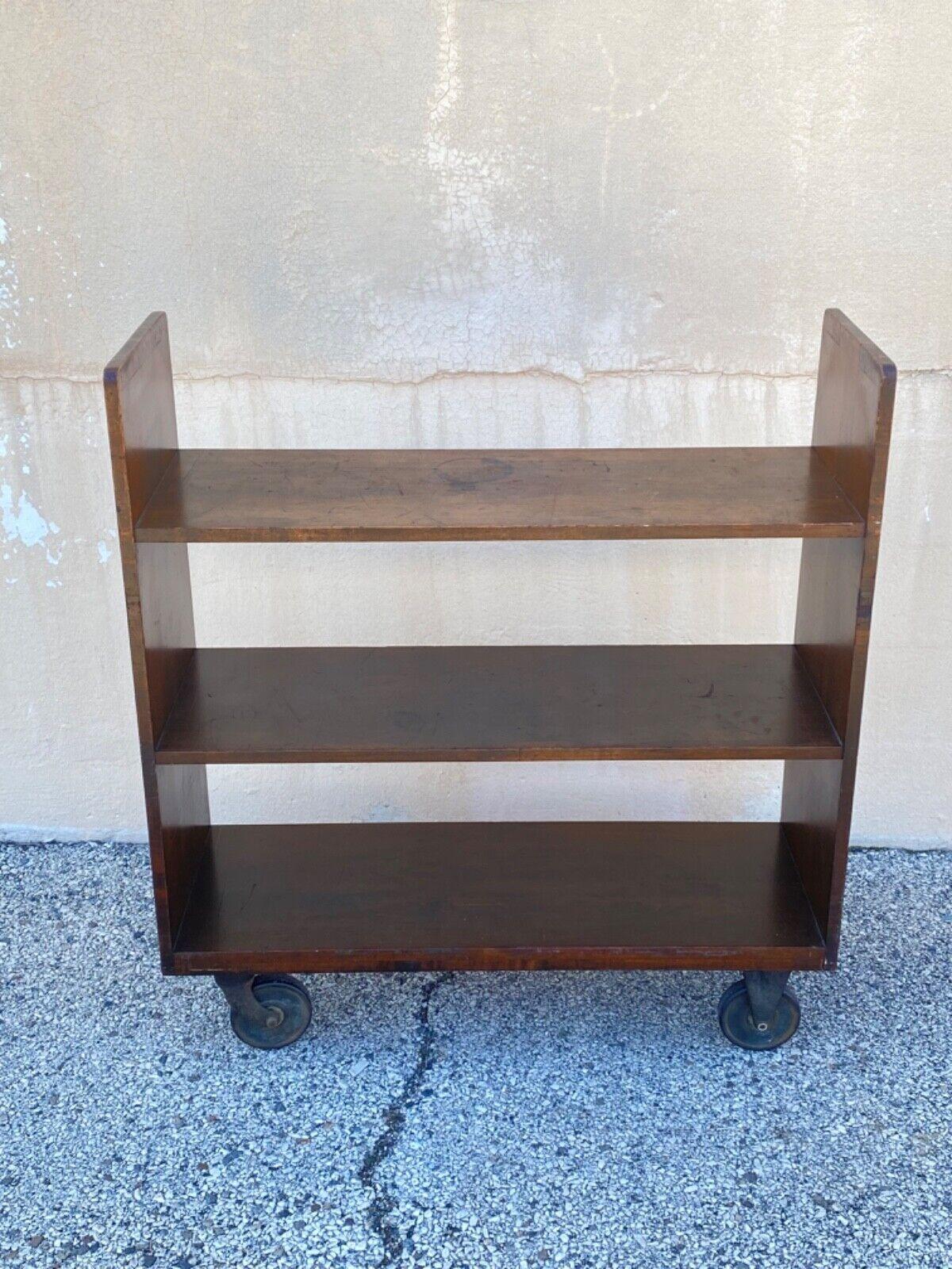 Vintage Arts & Crafts Wooden Rolling Library Book Cart Bookshelf with Cast Iron Wheels. Circa 1950s. Measurements: 43