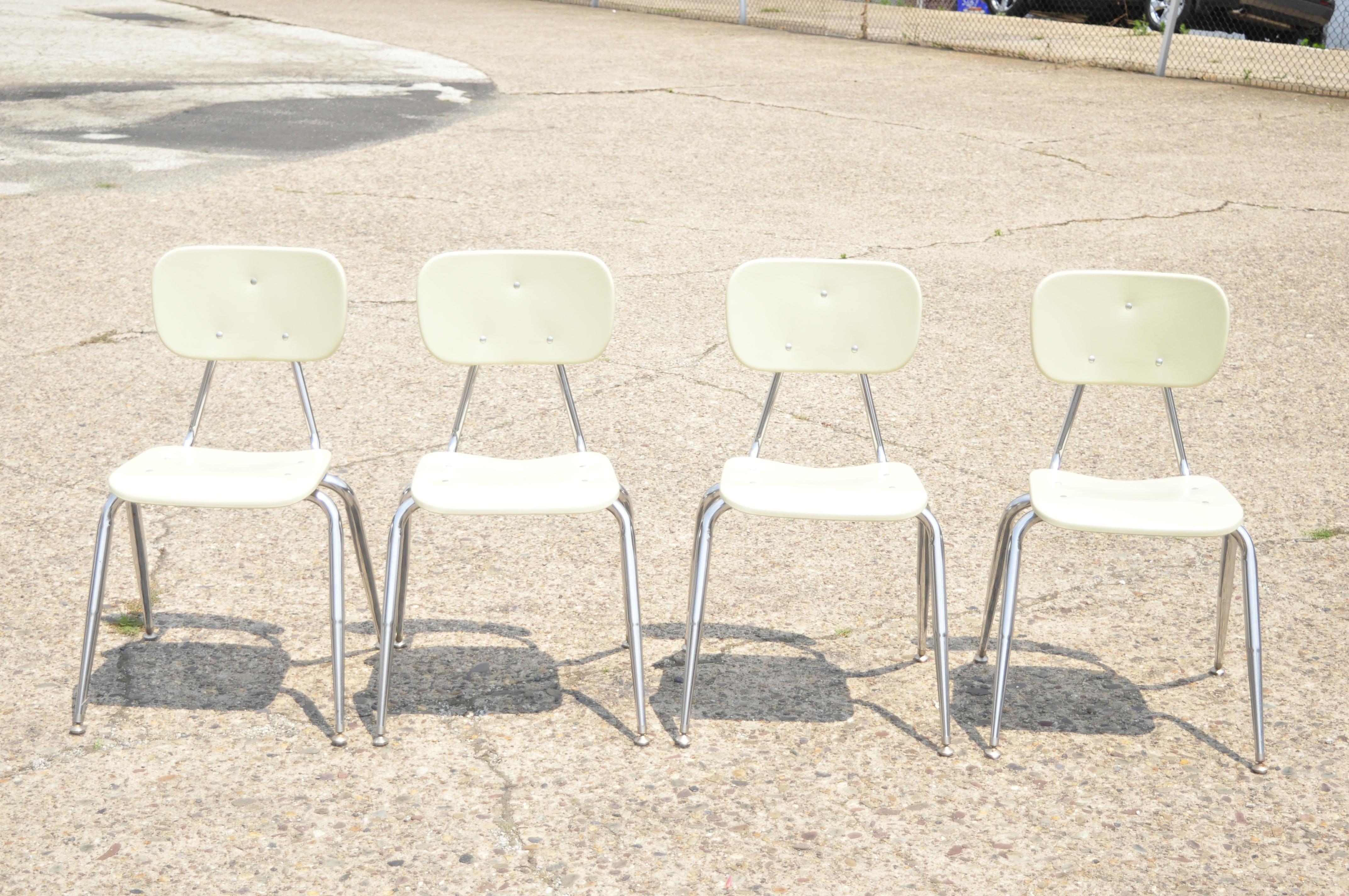 Vintage beige molded plastic chrome metal base stacking school side chair - Set of 4. Item features molded plastic back and seat, metal legs, stacking form, beige finish, quality American craftsmanship. Circa Late 20th Century. Measurements: 32.5