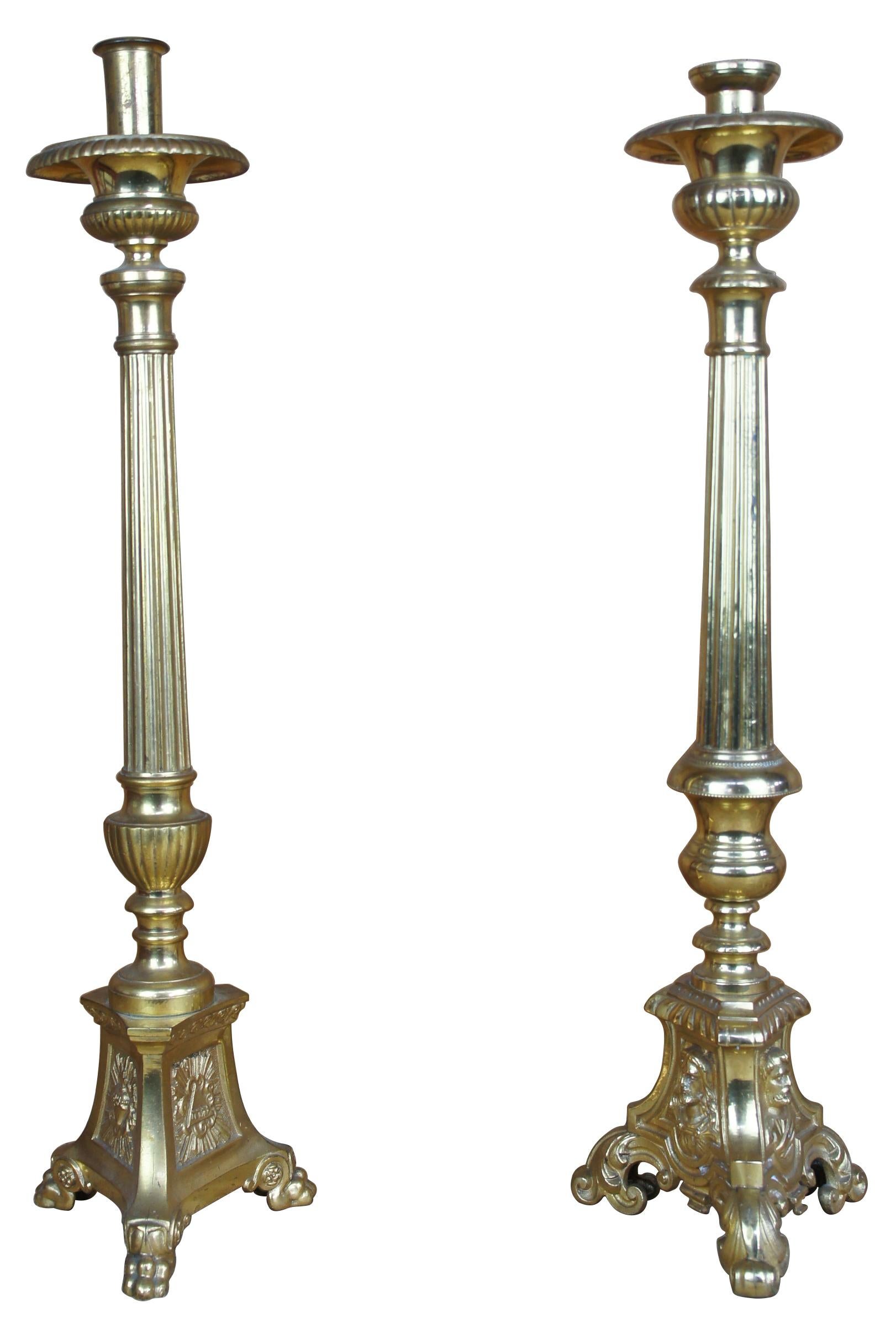 Vintage pair of brass ecclesiastical church alter candlesticks featuring Jesus, Mary and Joseph. Slightly different designs. Measures:22
