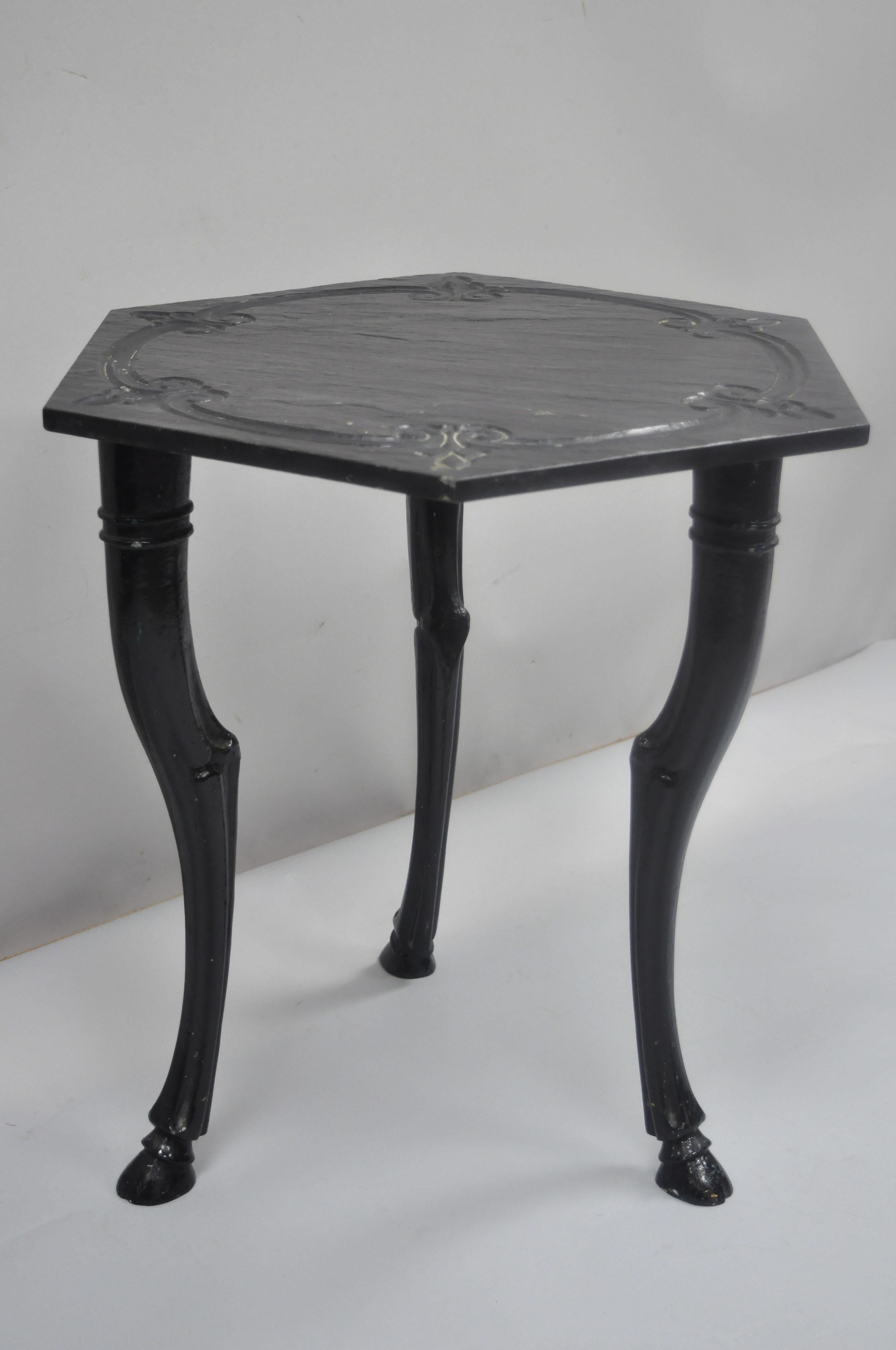 Vintage cast iron hoof foot French Regency style black slate top tripod side table. Item features heavy iron tripod hoof foot base, carved slate top (not attached), quality craftsmanship, great style and form, circa mid-20th century. Measurements: