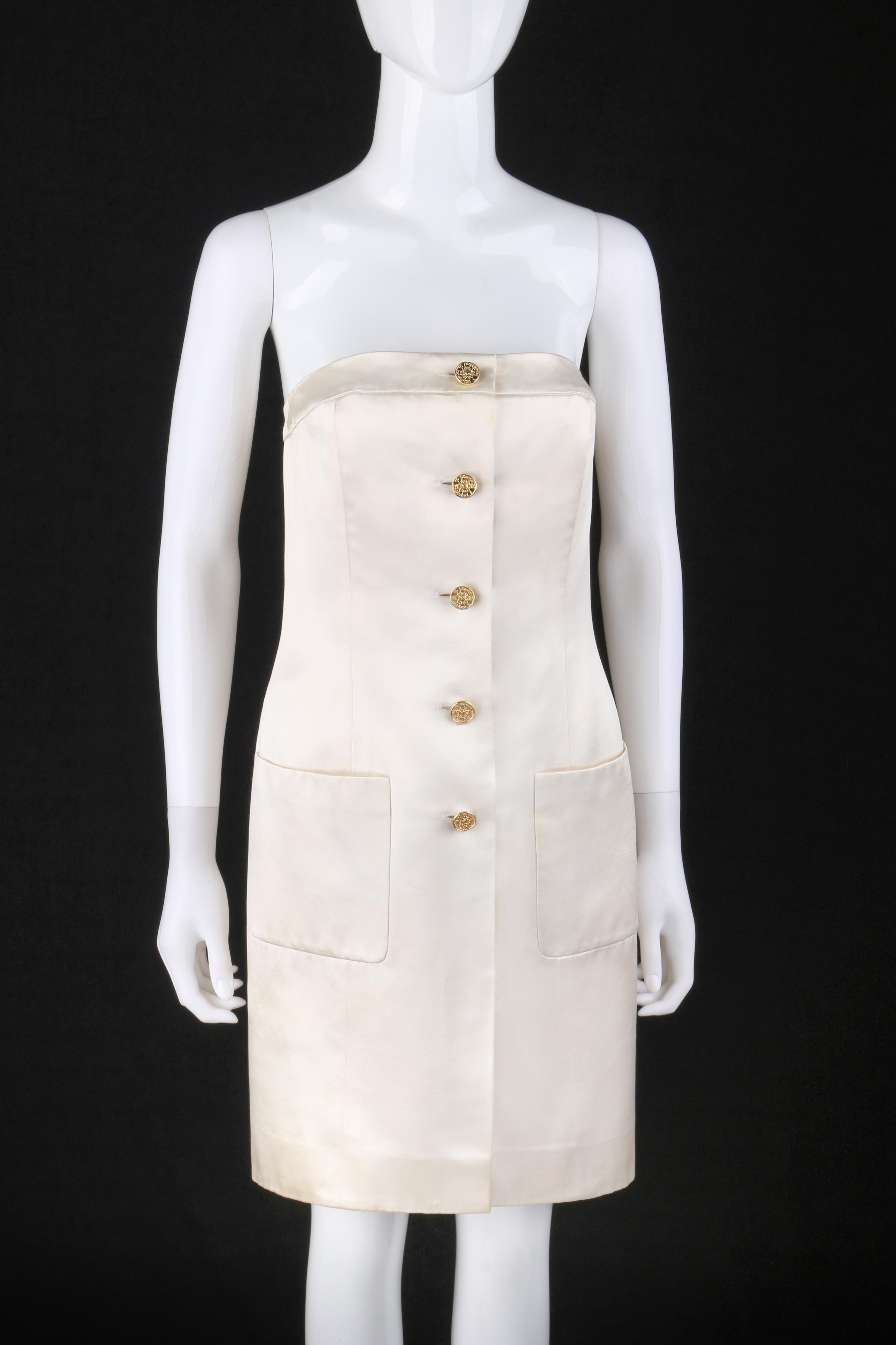 Vtg. CHANEL c.1980’s Ivory Champagne Satin Silk Button Up Strapless Dress
 
Circa: 1980’s 
Label(s): Chanel Boutique  
Style: Strapless dress
Color(s): Ivory / Champagne 
Lined: Yes
Unmarked Fabric Content: Silk
Additional Details / Inclusions:
