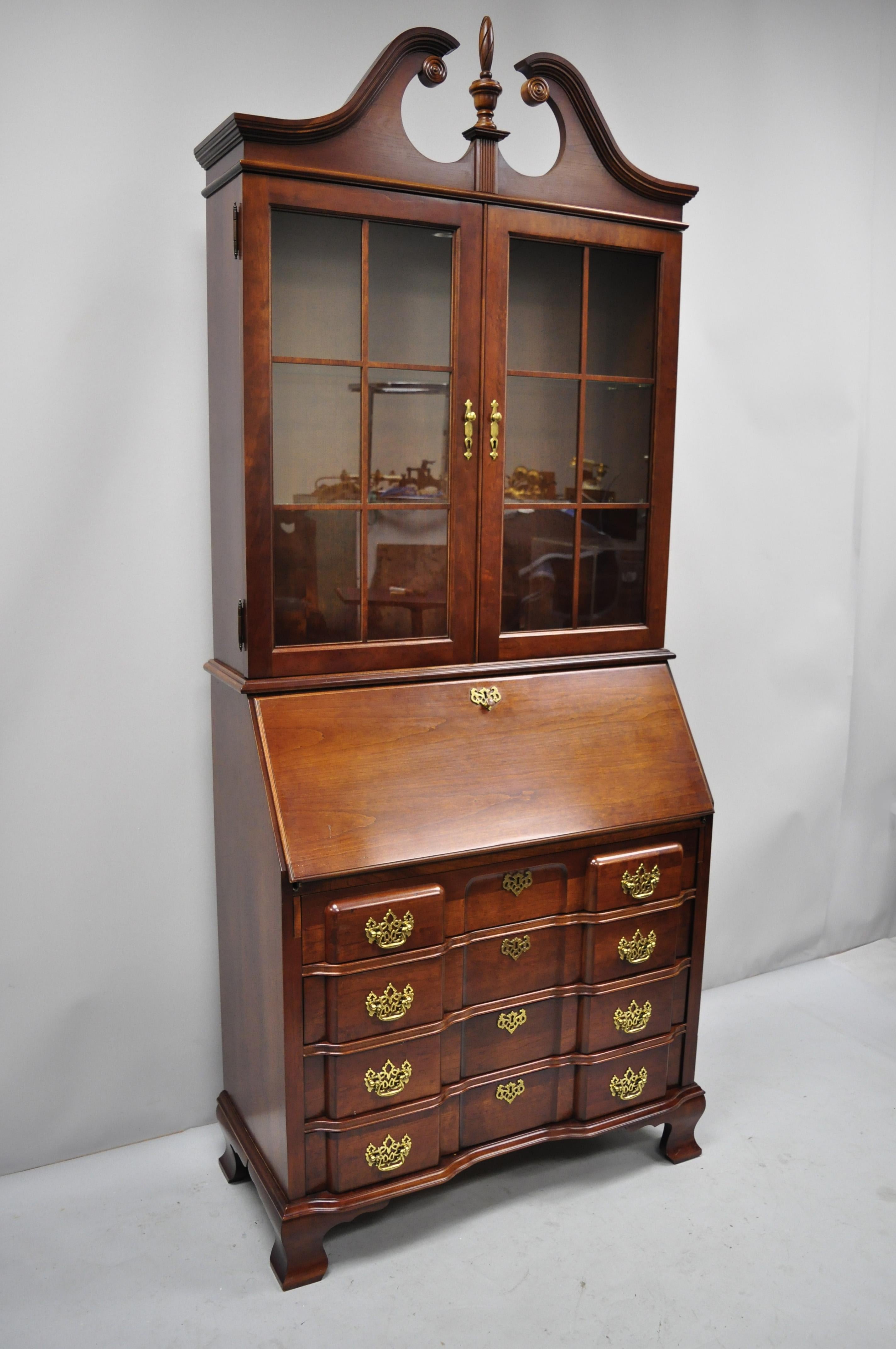 Vintage cherry Chippendale style block slant front secretary desk by Jasper Cabinet Co. Item features fitted interior, block front, solid wood construction, beautiful wood grain, lighted interior, original label, working lock and key, plate groves,