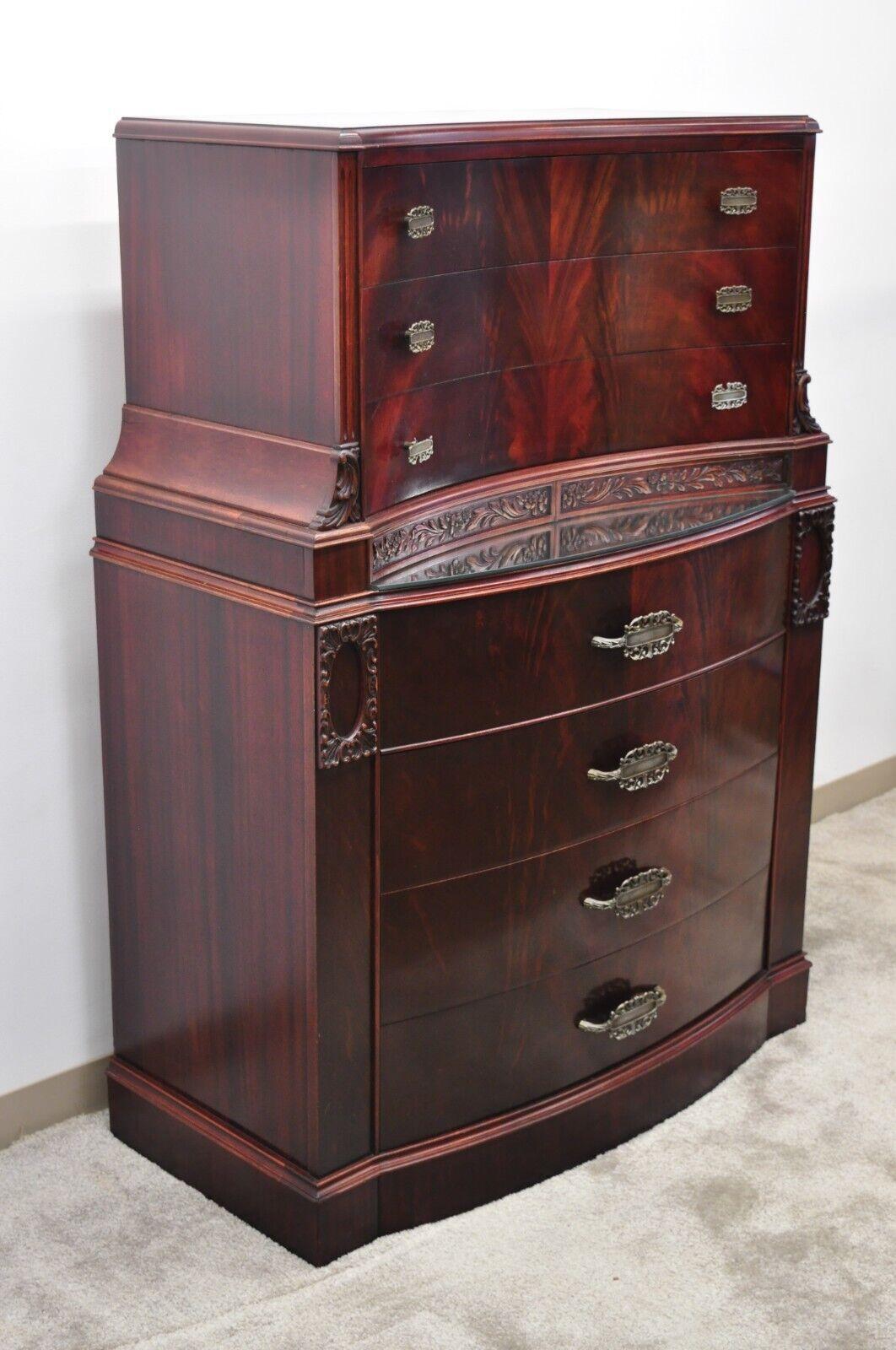 Vintage Chinese Chippendale flame mahogany bowed front tall chest on chest dresser. Item features a small mirrored surface, bowed front, beautiful wood grain, nicely carved details, 7 drawers, very nice vintage item, great style and form. circa