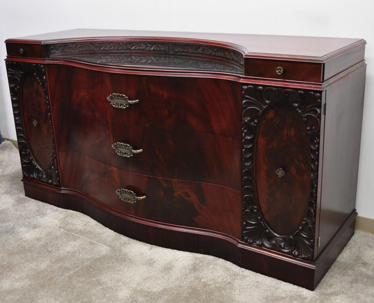 Vintage Chinese Chippendale Flame Mahogany Triple Dresser with Bowed Front and Mirror. Item features a mall mirrored surface, beautiful wood grain, nicely carved details, 2 swing doors, 9 drawers, very nice vintage item, great style and form. Circa