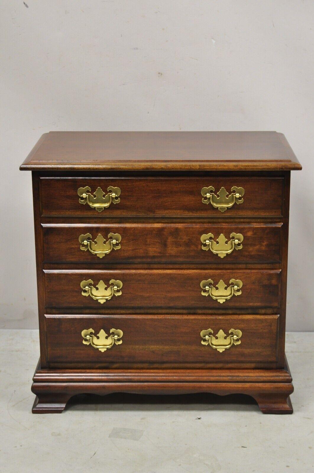 Vintage Chippendale Style Small 4 Drawer Bachelor Chest Cherry Nightstand Side Table. Item features solid wood construction, beautiful wood grain, 4 dovetailed drawers, solid brass hardware, quality American craftsmanship. Circa Late 20th Century.