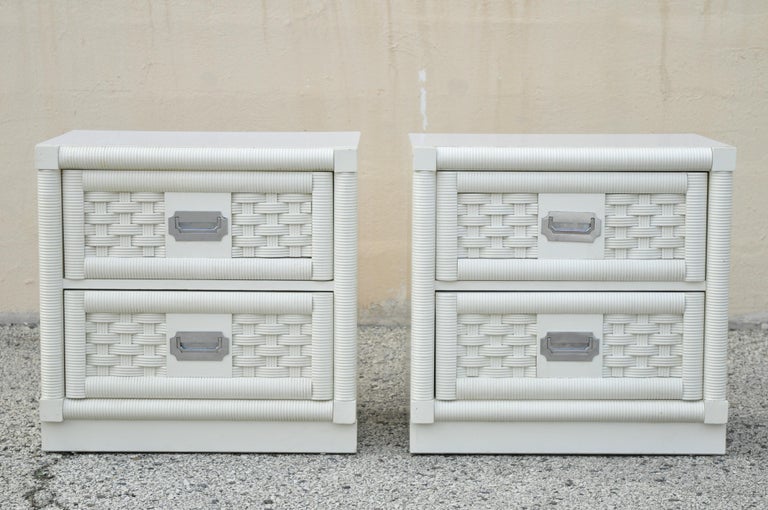 Vintage Dixie Cane Rattan Campaign Style White Hollywood Regency Nightstands - a Pair. Item features laminate top, chrome Campaign style handles, rattan and cane front, white/cream lacquer finish, 2 swing doors, 5 dovetailed drawers, original stamp,