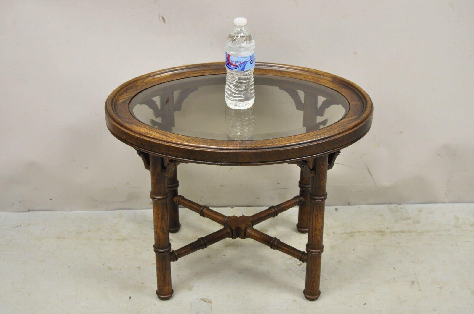 Vintage Faux Bamboo Chinese Chippendale Style Oval Small Glass Top Side Table - Pair. Item featured is a nice smaller size, oval beveled glass tops, cross stretcher base, solid wood frame, distressed finish, very nice vintage pair, great style and