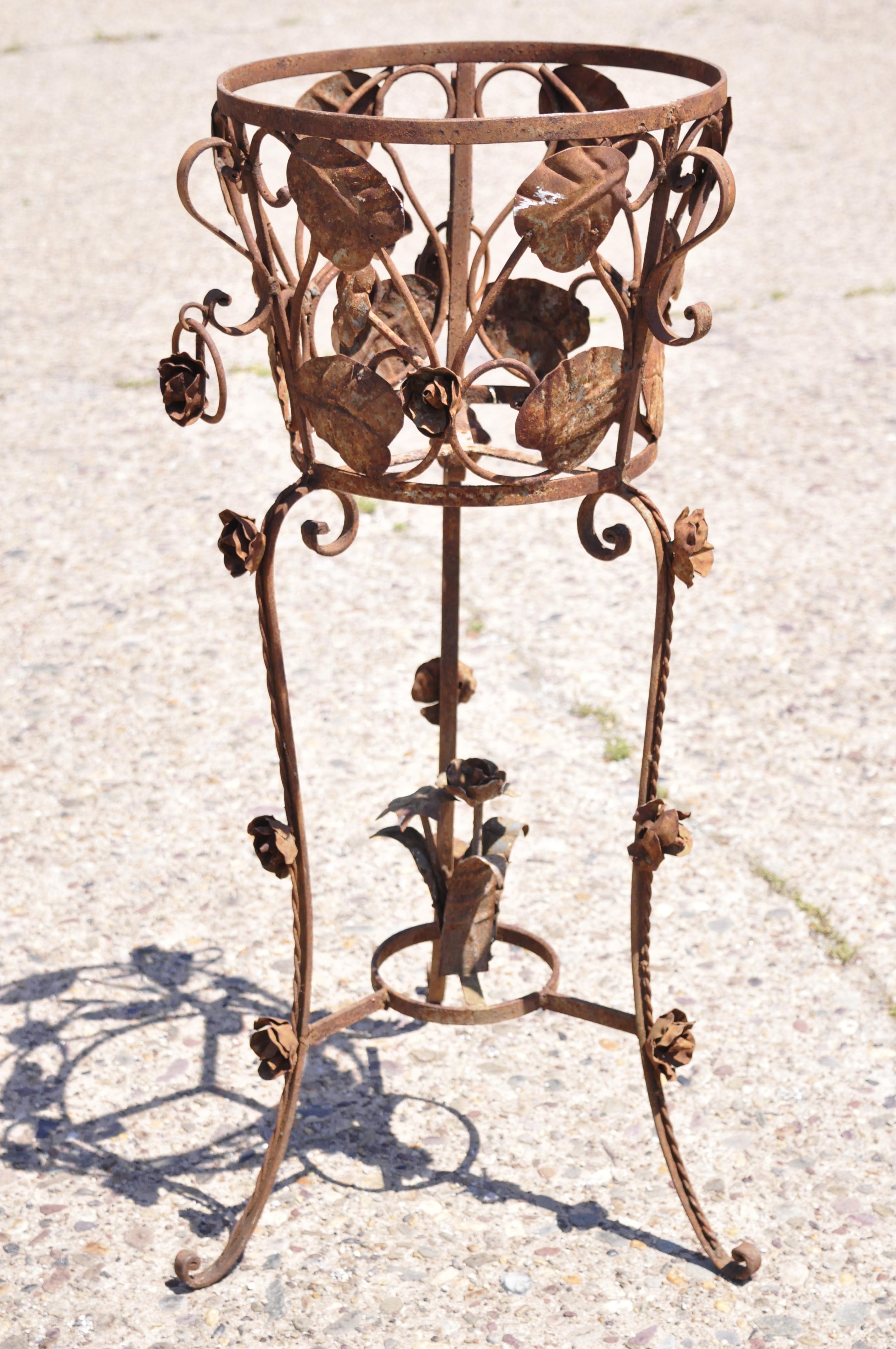 Vintage French Art Nouveau wrought iron leaf vine garden planter pot flower stand. Item features leaf and vine design work, scrolling base, wrought iron construction, great style and form. Circa Mid 20th Century. Measurements: 36