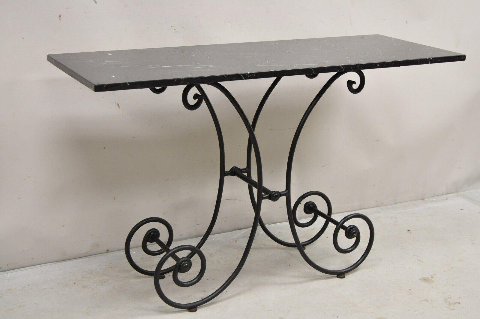 Vintage French Country Pastry Style Scrolling Wrought Iron Black Marble Top Bakers's Console Table. Circa Early to Mid 20th Century
Measurements: 30