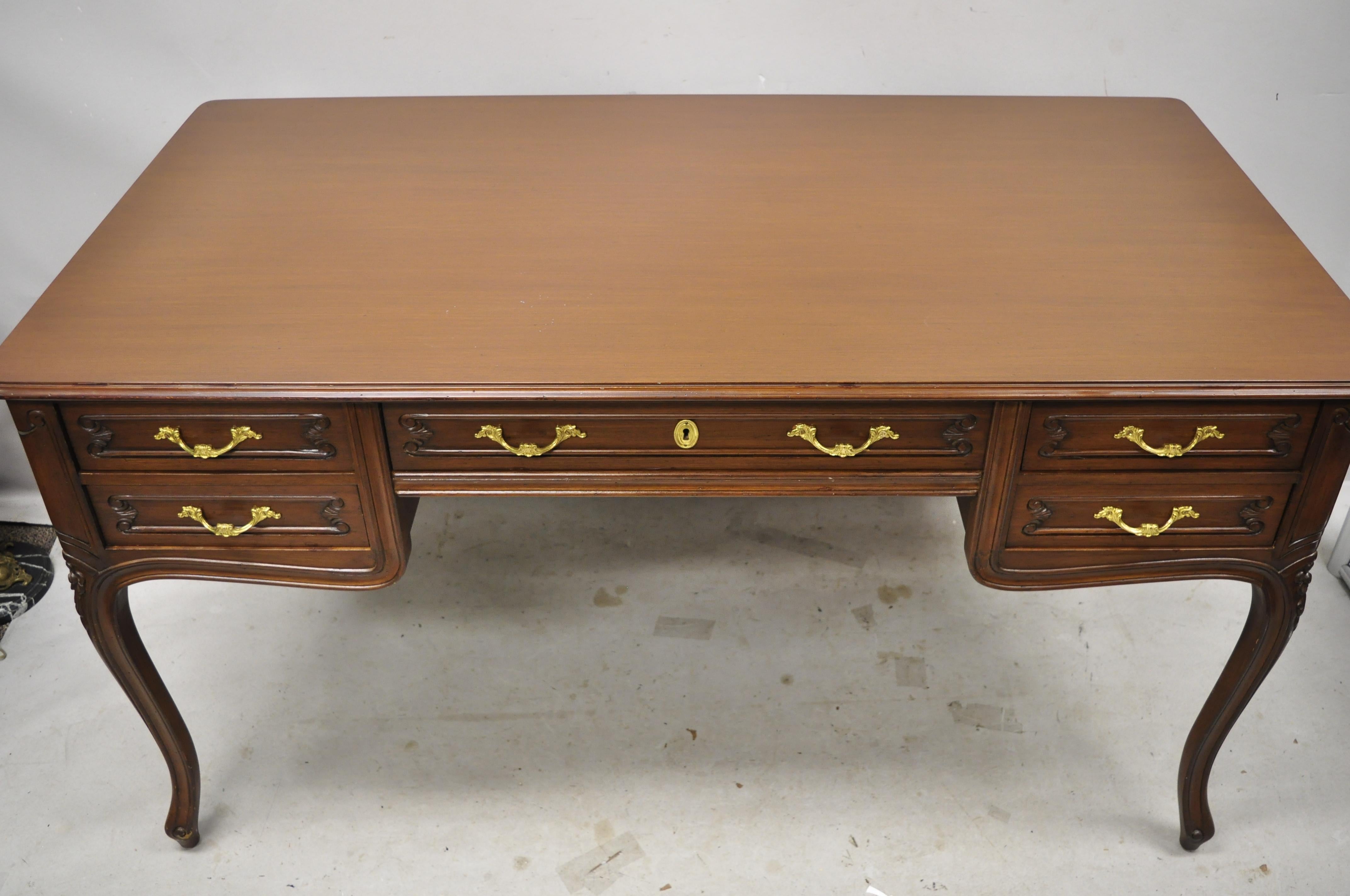 Vintage French Country Provincial Louis XV style executive office writing desk with glass top. Item features a custom glass top, solid wood construction, distressed finish, nicely carved details, finished back, 5 dovetailed drawers, cabriole legs,