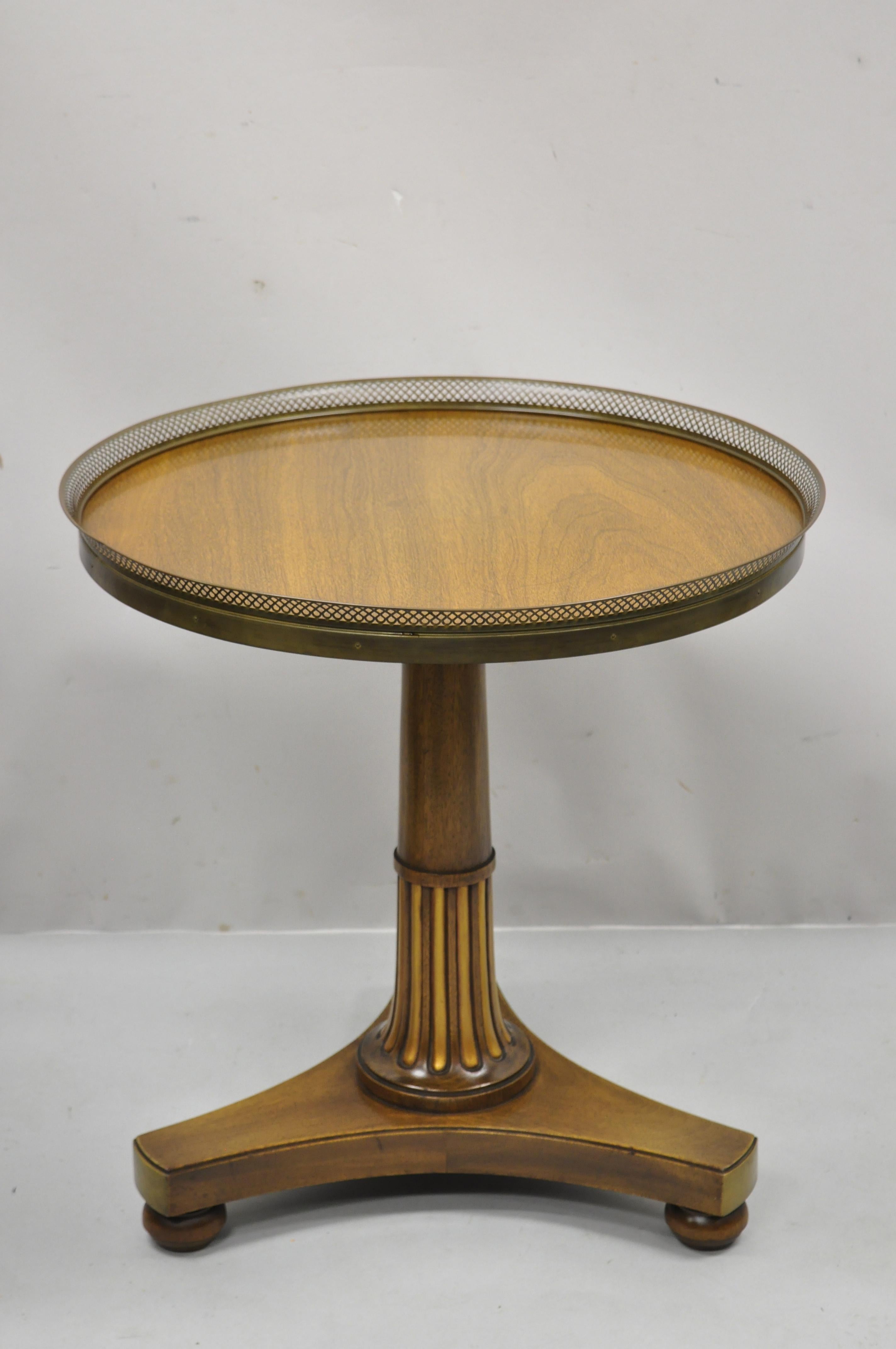 Vintage French Empire mahogany pedestal base round accent center table with brass gallery. Item features pierced brass gallery, pedestal base, gold gilt details, beautiful wood grain, quality American craftsmanship, great style and form. Circa mid
