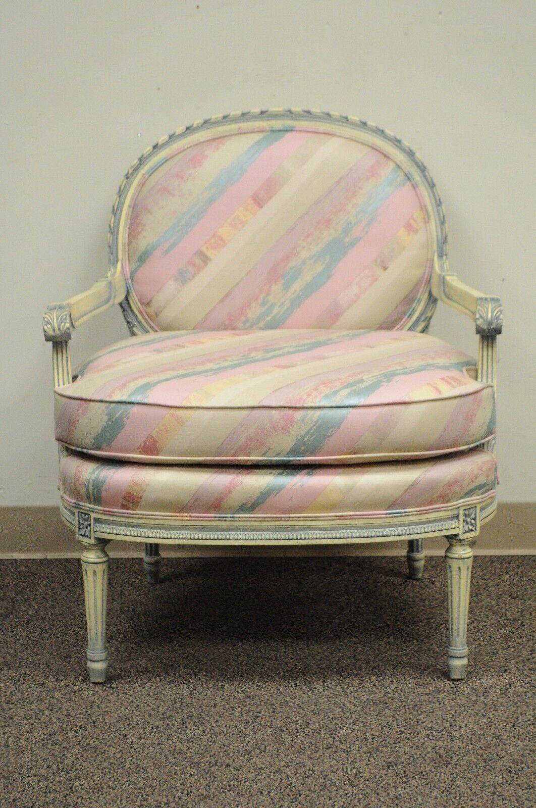 Vintage French Louis XVI Style Boudoir Armchair. Item features a solid Carved Wood Frame, Column Legs, Blue and Cream Finish to the Wood which matches the Blue and Pink Upholstery, Classic French Louis XVI Form. Circa Mid 20th Century, USA.