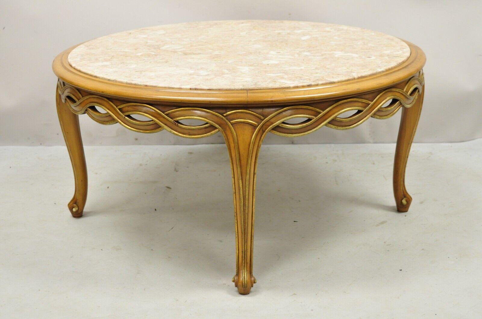 Vintage French Provincial Hollywood Regency pretzel skirt marble top coffee table. Item features a carved interlocking woven skirt, inset marble top, cabriole legs, very nice vintage item, great style and form. Circa mid 20th century.
Measurements: