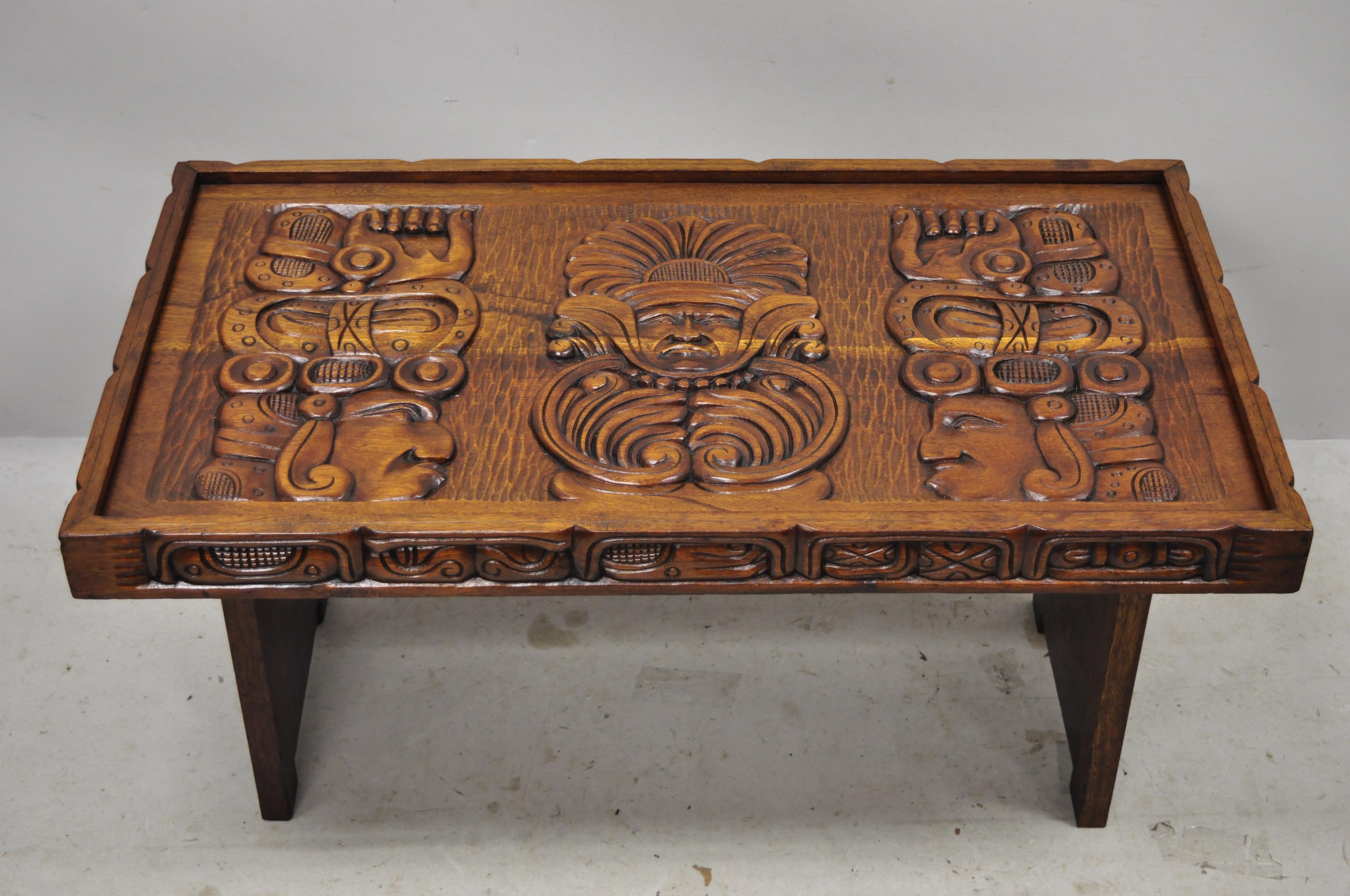 Vintage Hawaiian figural faces carved Makana hut boho chic jungle room coffee table. Item features glass top, relief carved figural faces to top and sides, solid wood frame, beautiful wood grain, very nice vintage item, great style and form, circa