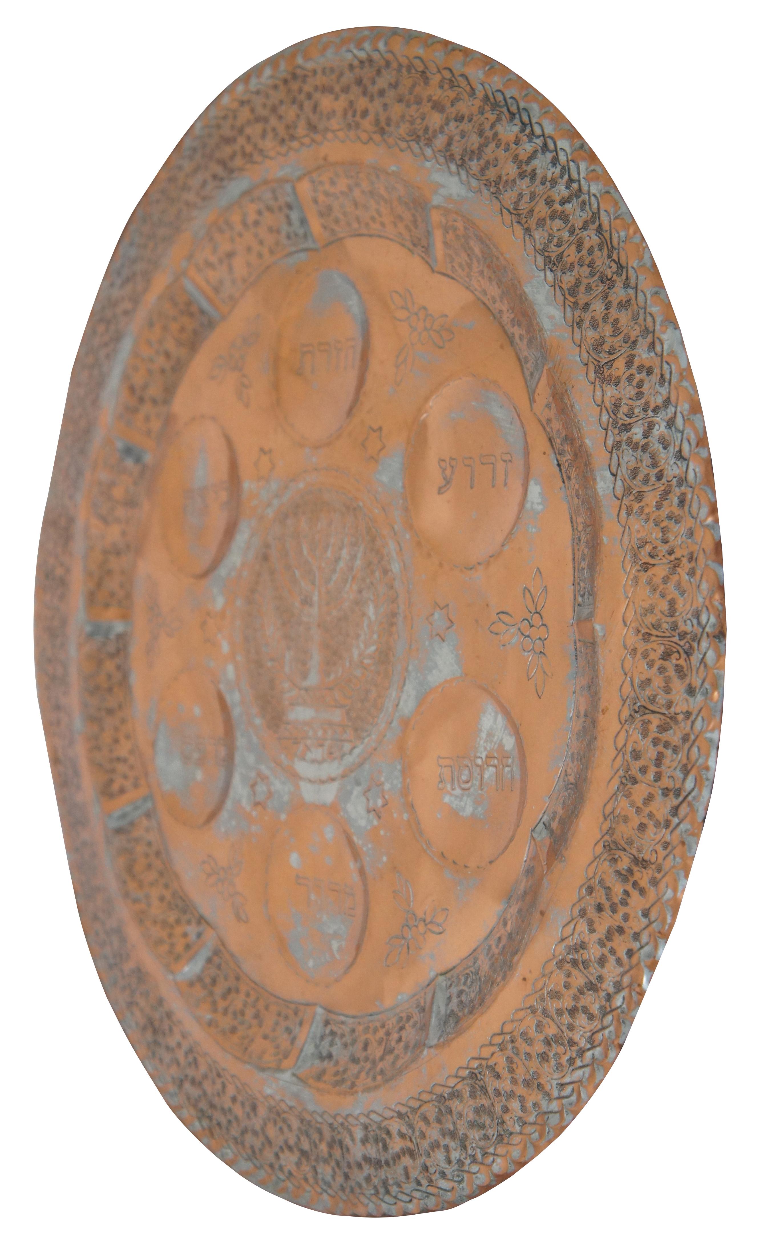 Vintage chased copper plate / platter for the Jewish celebration of the Passover Seder, with attached hook for displaying on the wall. Marked “Handmade in Israel” on hook. Attributed to Messica. Measure: 16