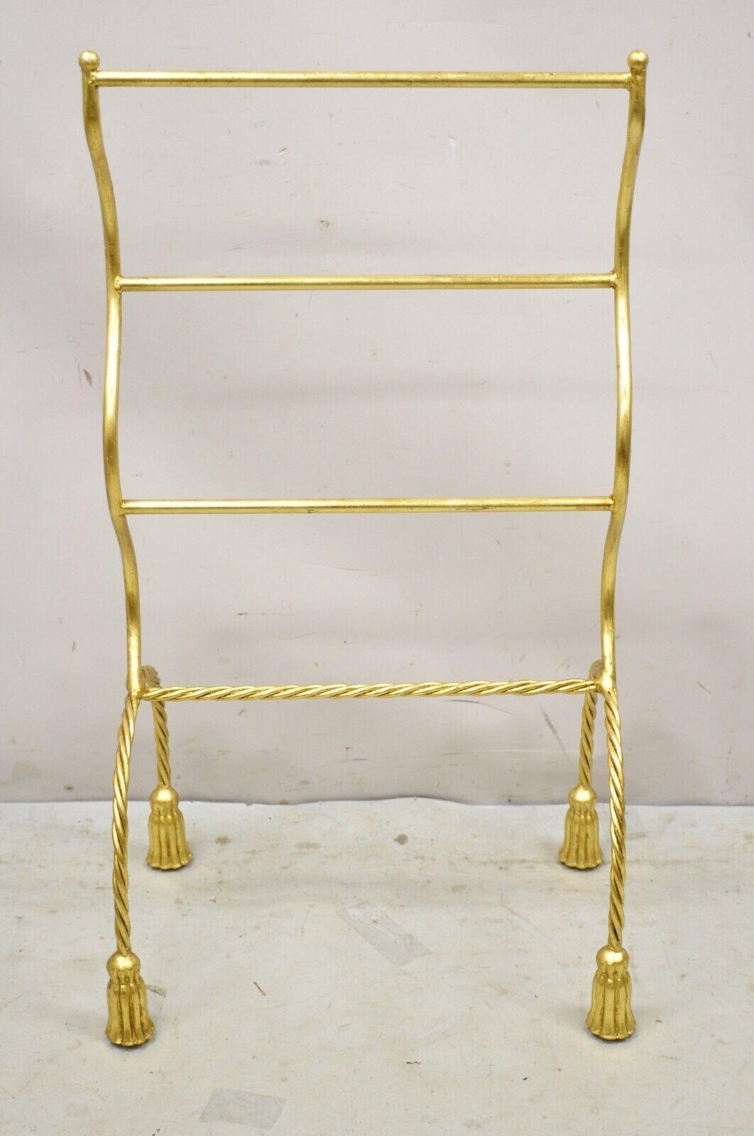 Vintage Italian Hollywood Regency Gold Gilt Metal Iron Towel Rack with Tassel Feet. Item features a gold gilt finish, sculptural metal frame, tassel form feet, quality Italian craftsmanship, great style and form. Circa Mid to Late 20th Century.