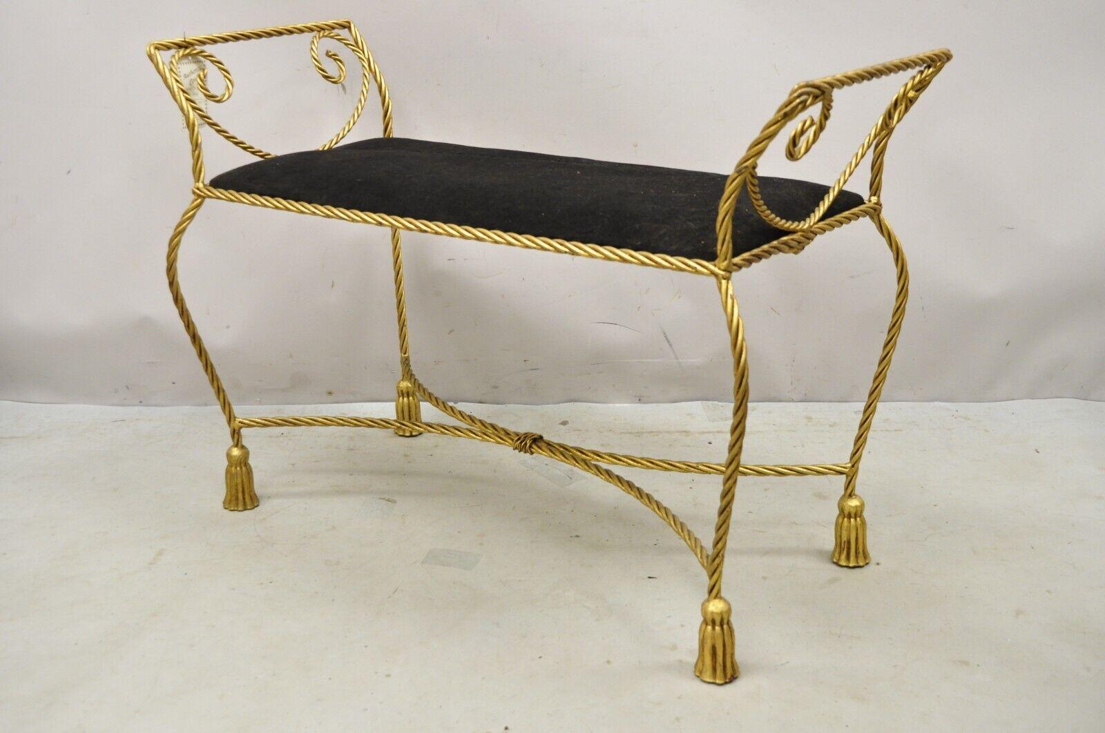 Vintage Italian Hollywood Regency Iron Rope & Tassel Gold Gilt Leaf Bench with Black Seat. Item features a scrolling iron frame, gold gilt finish, rope and tassel design, very nice vintage item, quality Italian craftsmanship, great style and form.