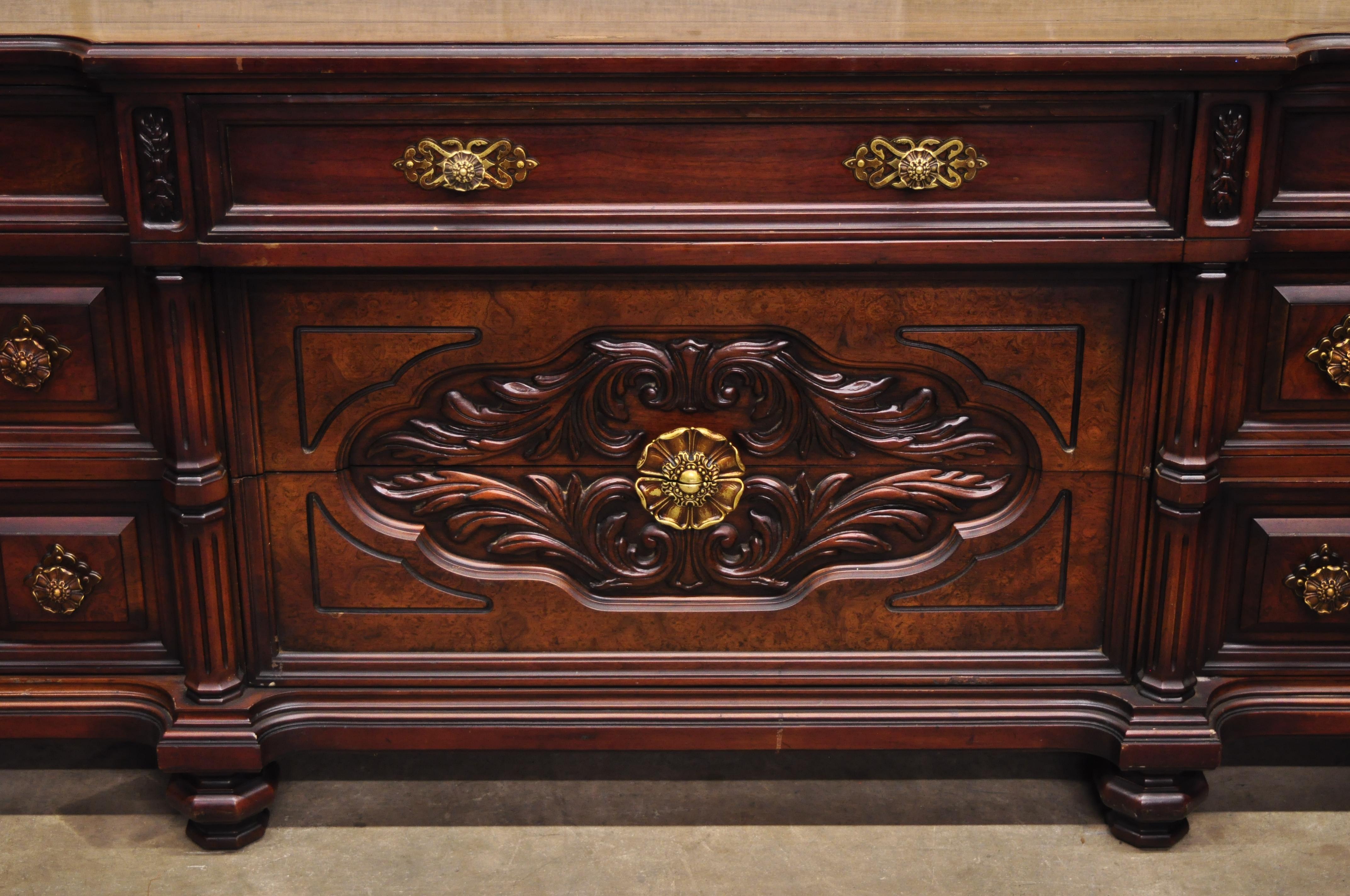 Vintage Italian Mediterranean style Hollywood Regency carved wooden credenza long dresser. Item features bun feet, ornate pulls, heavy solid wood construction, nicely carved details, 9 dovetailed drawers, very nice vintage item, great style and