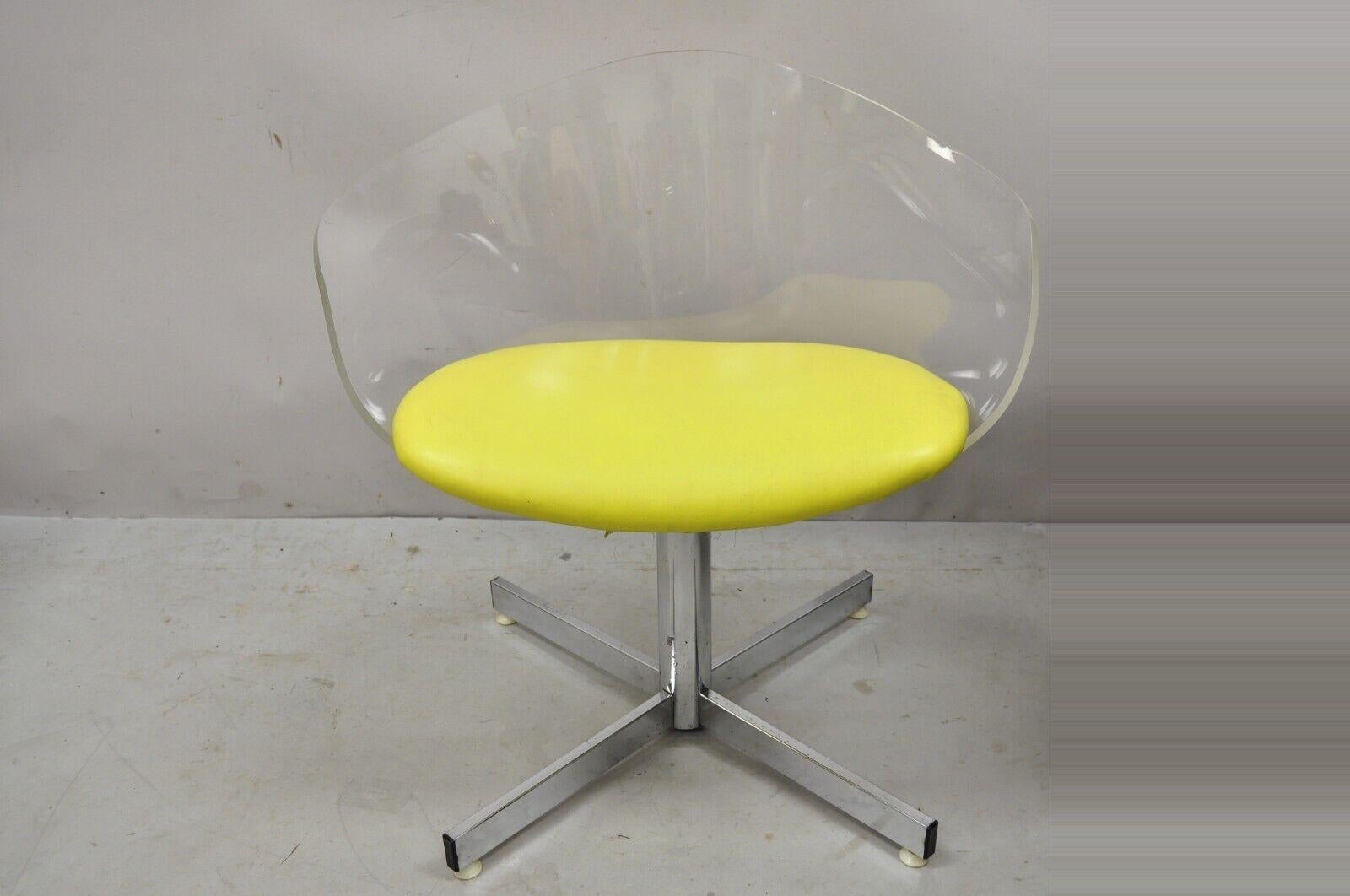 Vintage Jansko clear sculpted Lucite Mid-Century Modern yellow Vinyl swivel chair. Item features a swivel seat, sculptural clear lucite frame, chrome pedestal base, original label, very nice vintage item, great style and form. Circa mid 20th