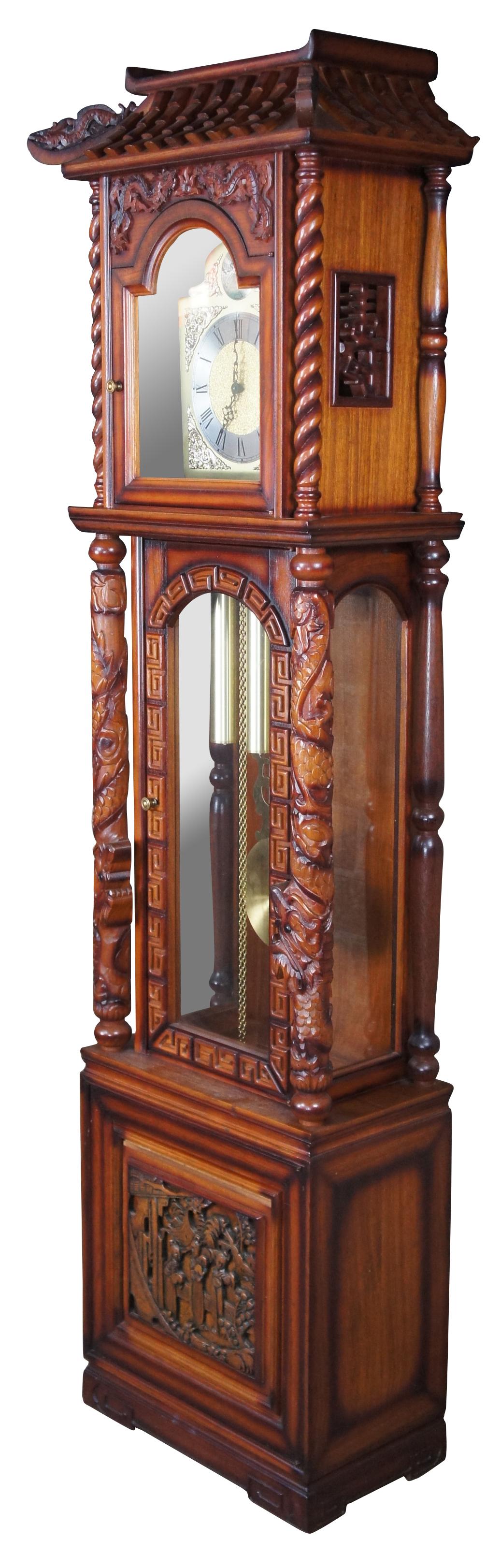 An impressive oriental chinoiserie Tempus Fugit Grandfather Clock made in Okinawa Japan, circa 1970s. Hand Crafted from oak with pagoda form crown and dragon motif throughout. Features central windows flanked by barley twised and dragon carved