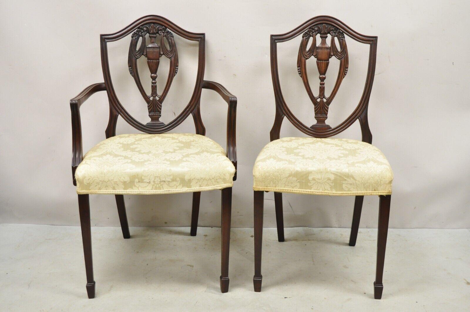 Vintage Mahogany Shield Back Hepplewhite Style Duncan Phyfe Dining Chairs - Set of 10. Item features a very rare set of 10 chairs, (2) armchairs, (8) side chairs, urn and drape carved backrests, shapely shield backs, very nice vintage set, great