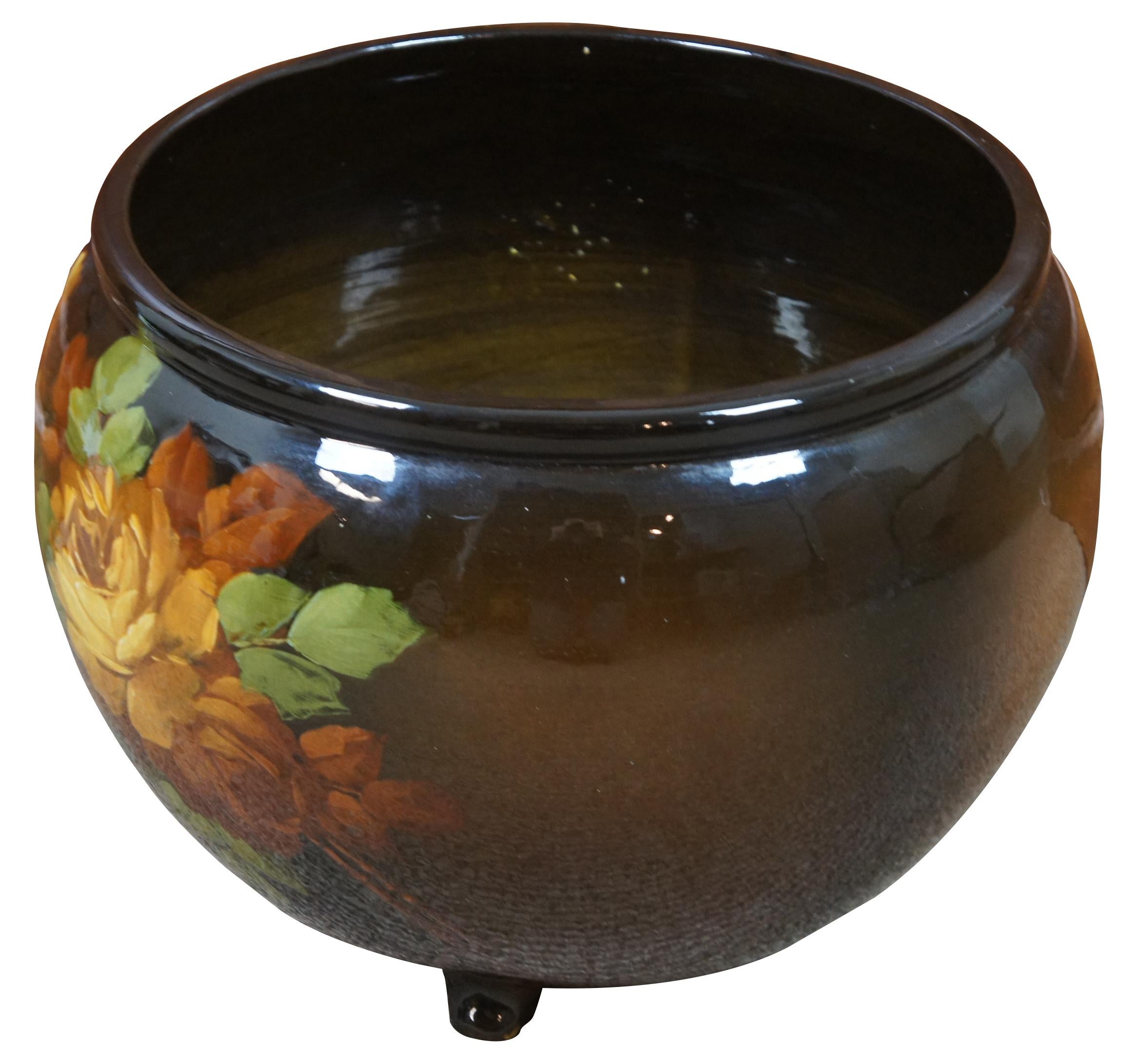 Vintage brown and green ceramic planter painted with yellow roses, by McCoy pottery and marked Loy-Nel-Art.
  