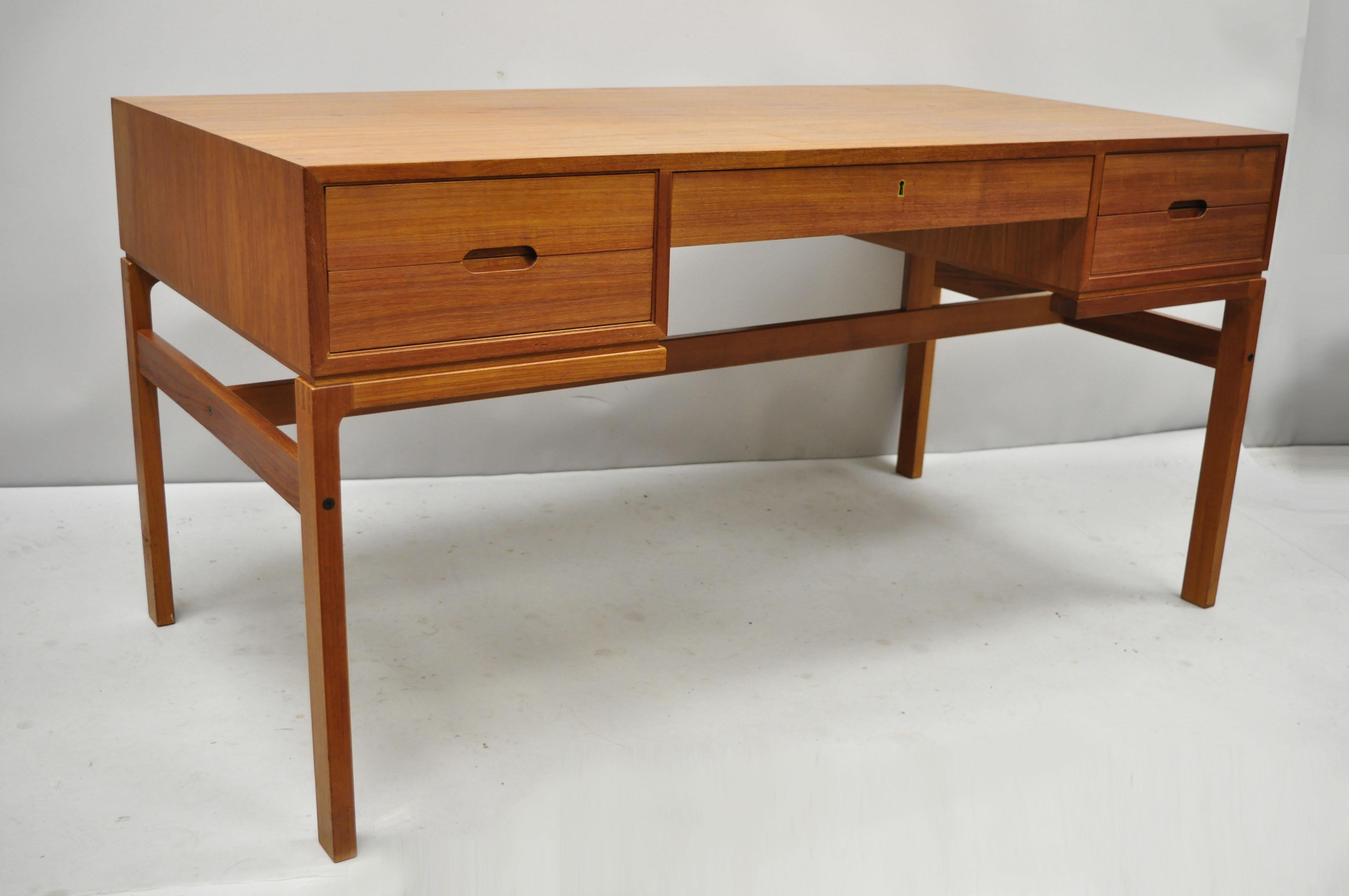 Vintage midcentury Danish modern teak wood floating top writing desk with cubby back. Item features open bookcase rear, unique joinery, solid wood construction, beautiful wood grain, finished back, original stamp, no key, but unlocked, 4 dovetailed
