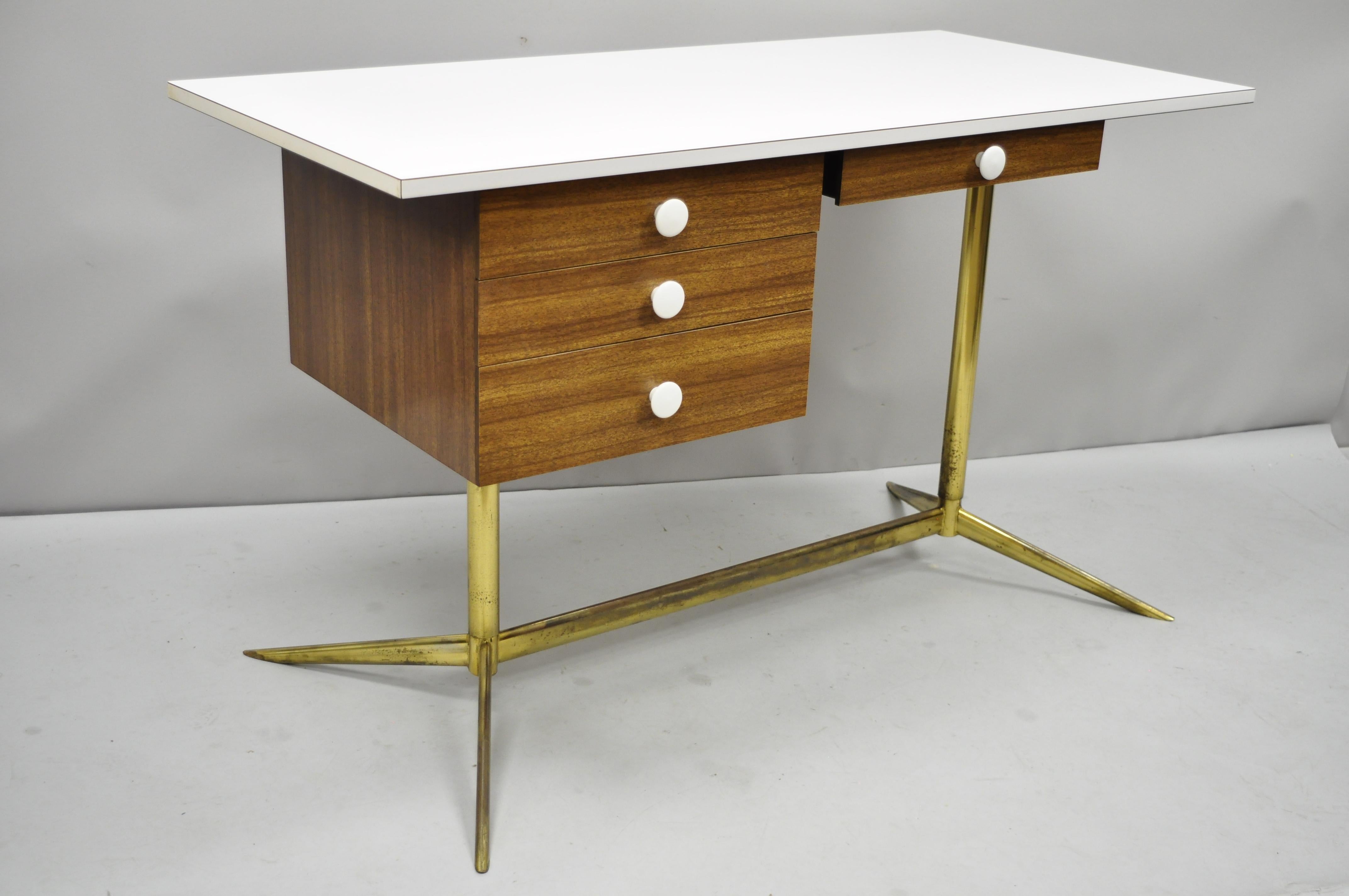 Vintage Mid-Century Modern Atomic Era brass base laminate Italian style writing desk. Item features white laminate/formica top, brass plated metal base, wood grain laminate/formica, clean modernist lines, sleek sculptural form, circa 1960s.