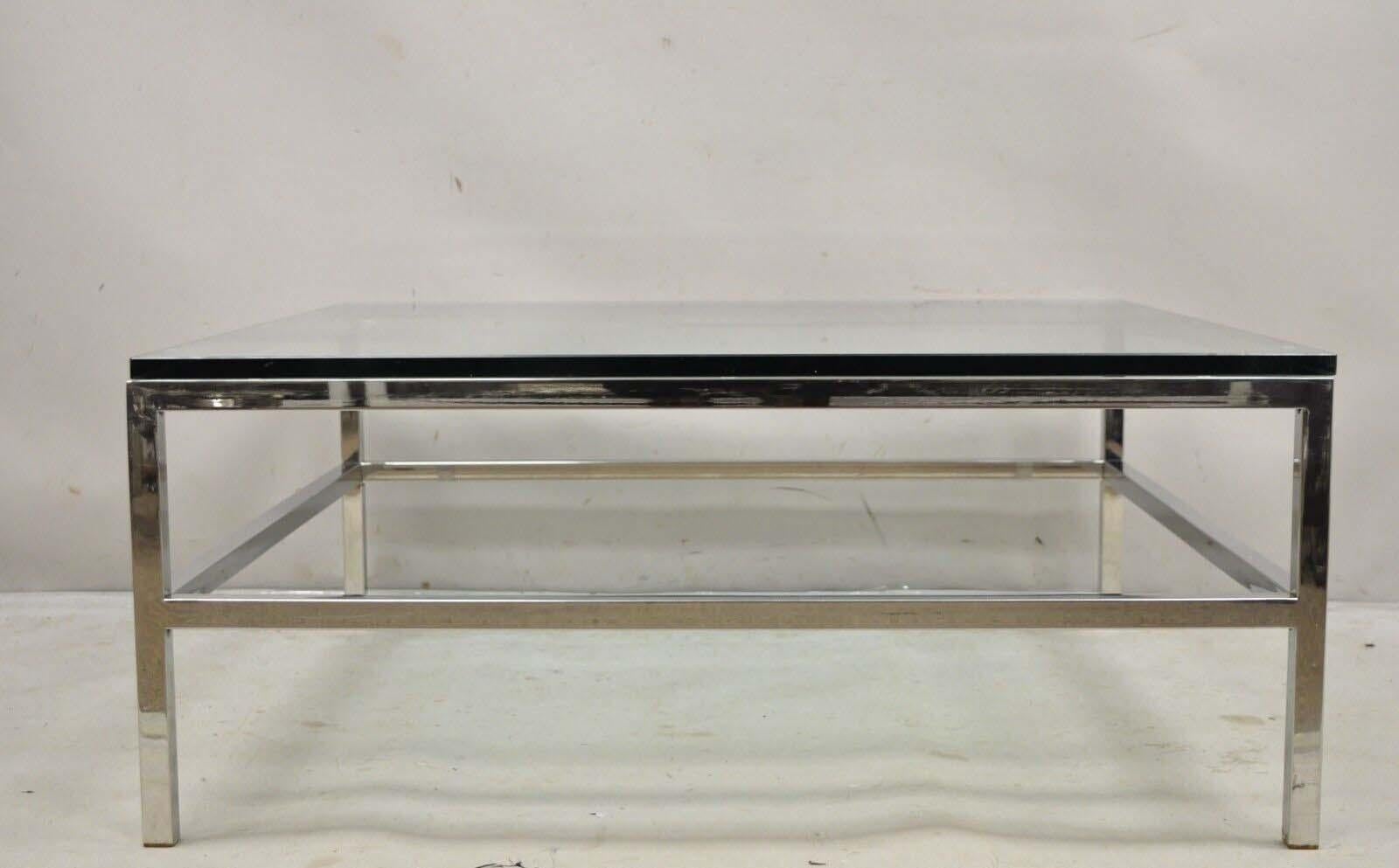 Vintage Mid Century Modern Milo Baughman Style Chrome & Glass Square Coffee Table. Item features a thick square glass top, polished chrome frame with stretcher base, clean modernist lines, great style and form. Circa  Late 20th Century.