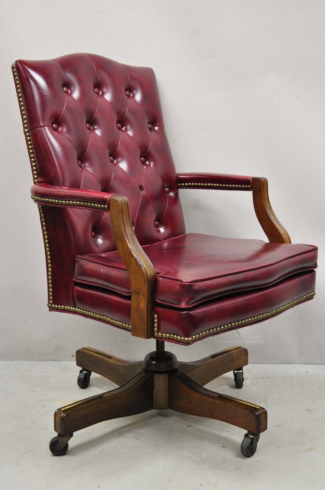 Vintage Oxblood Burgundy Naugahyde Chesterfield Style Swivel Office Desk Executive Chair. Item features a swivel and tilt seat, adjustable height, oxblood burgundy button tufted naugahyde/vinyl upholstery, very nice vintage item. Circa Mid to Late