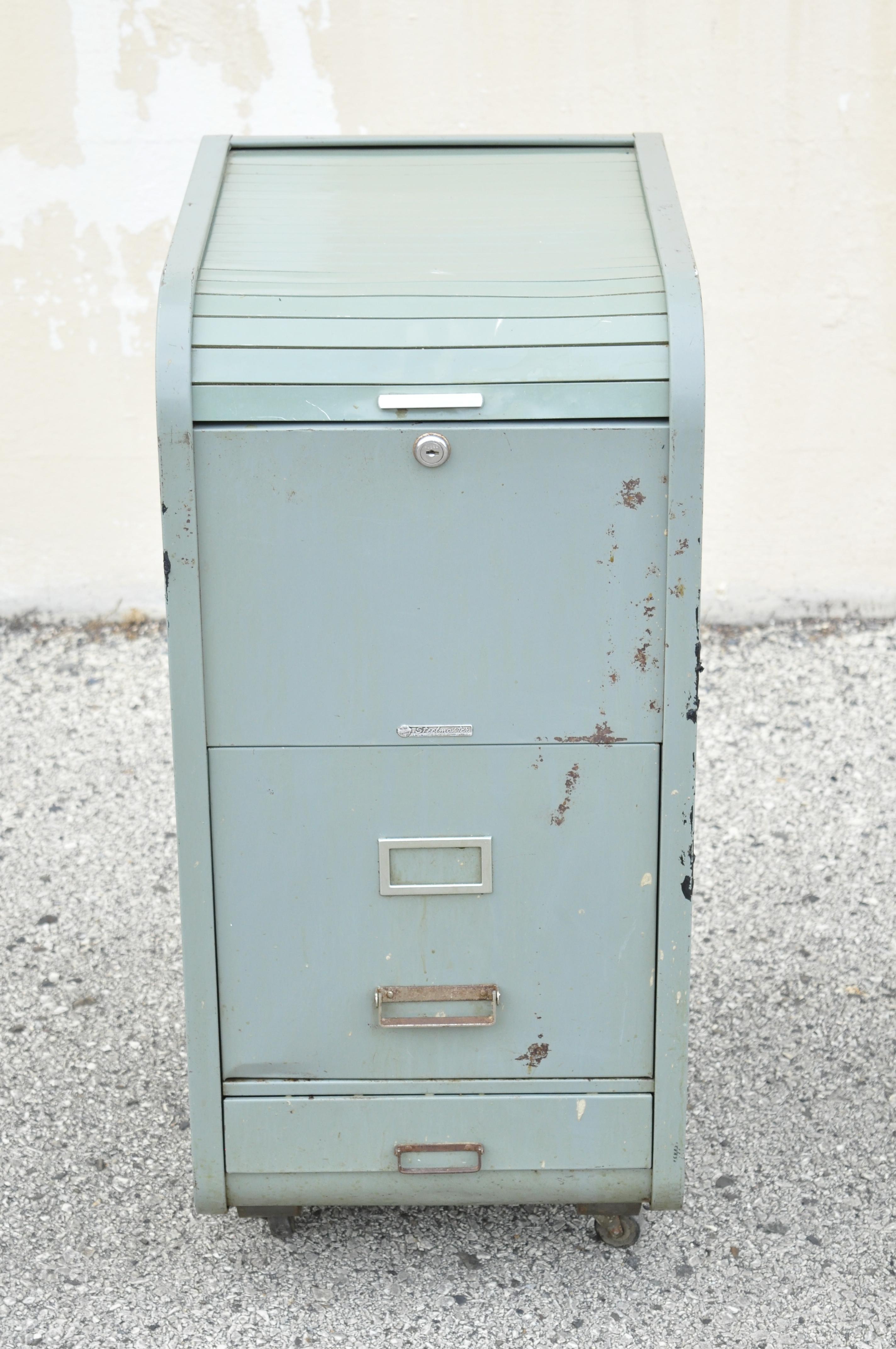 Vintage steelmaster steel metal roll top American Industrial steampunk office file cabinet. Item features roll top, 2 drawers, rolling casters, original green painted finish, original label, quality American craftsmanship, great style and form.