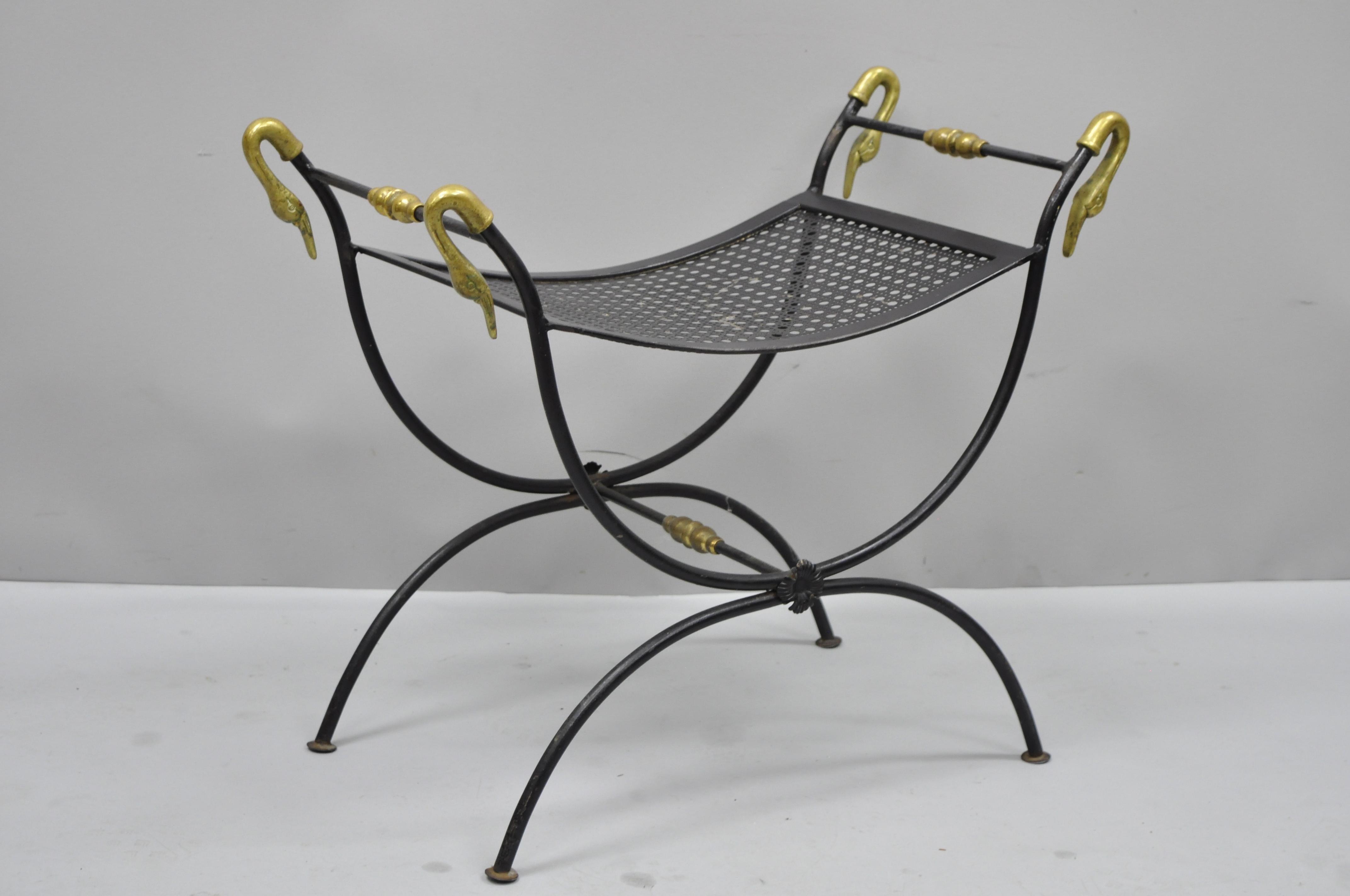 Vintage wrought iron and brass classical swan French Regency style curule vanity bench. Item features wrought iron frame, brass swan head finials, Curule design, metal mesh seat, great style and form, circa mid-20th century. Measurements: 21