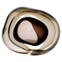 Vug en ámbar oscuro y aceituna, obra de vidrio amorfo fluido de Samantha Donaldson