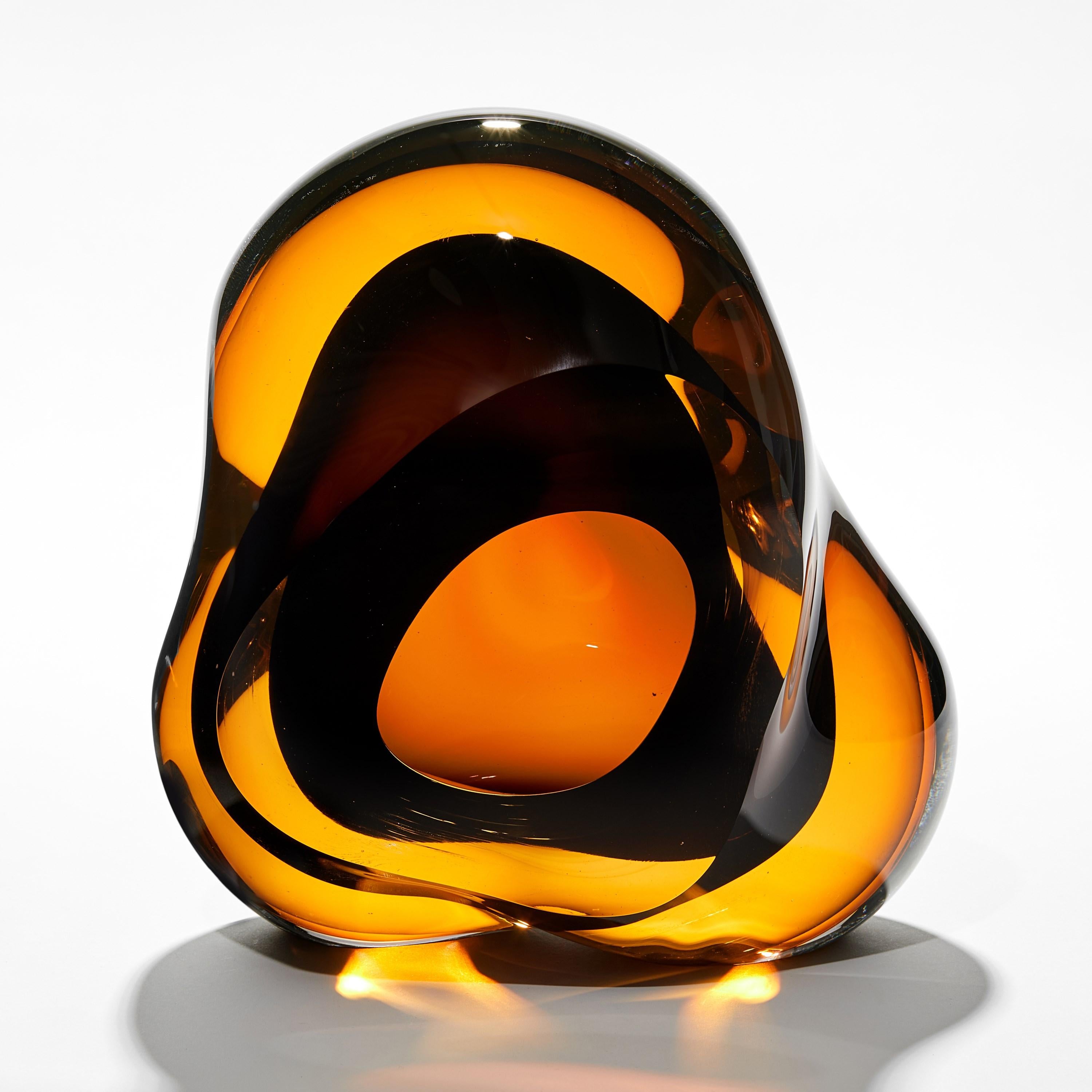 'Vug in Olivin Gold & Brown' is a unique handblown sculpture by the British artist, Samantha Donaldson.

Created by layers of coloured glass, the transparent colours merge and create further hues throughout the piece. An additional optical