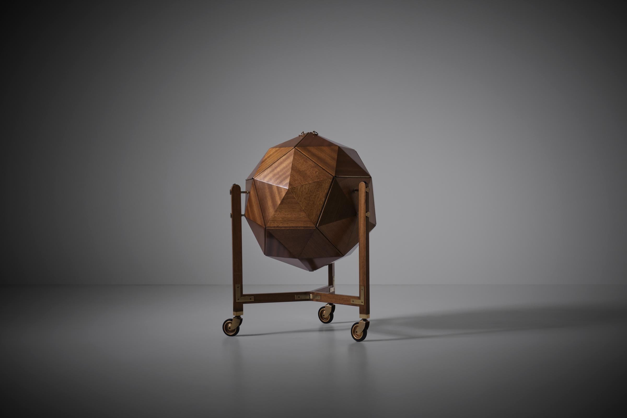 Sculptural Polyhedron shaped bar cabinet by M. Vuillermoz for Dambrine, France 1960s. Stunning three dimensional design constructed out of solid Mahogany triangular elements merged together into a larger pentagonal shape and finished with nice brass