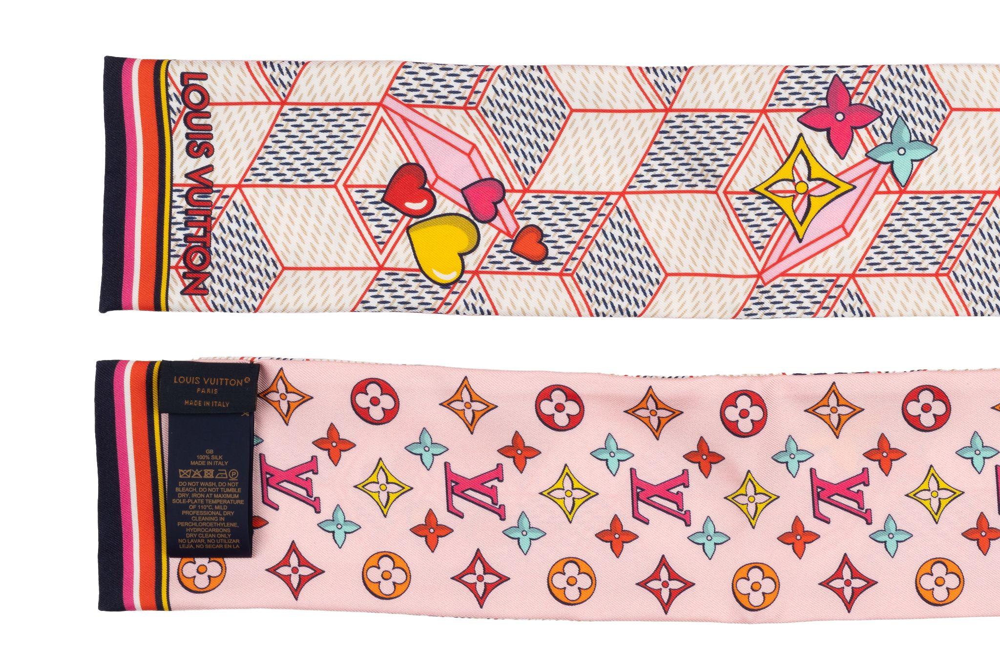 Louis Vuitton Silk Damier Pop Up Bandeau. This very chic 100% silk scarf features an attractive design of a colorful LV print on a pink background. The reverse side features printed shapes on a pink and white background. It's brand new and comes
