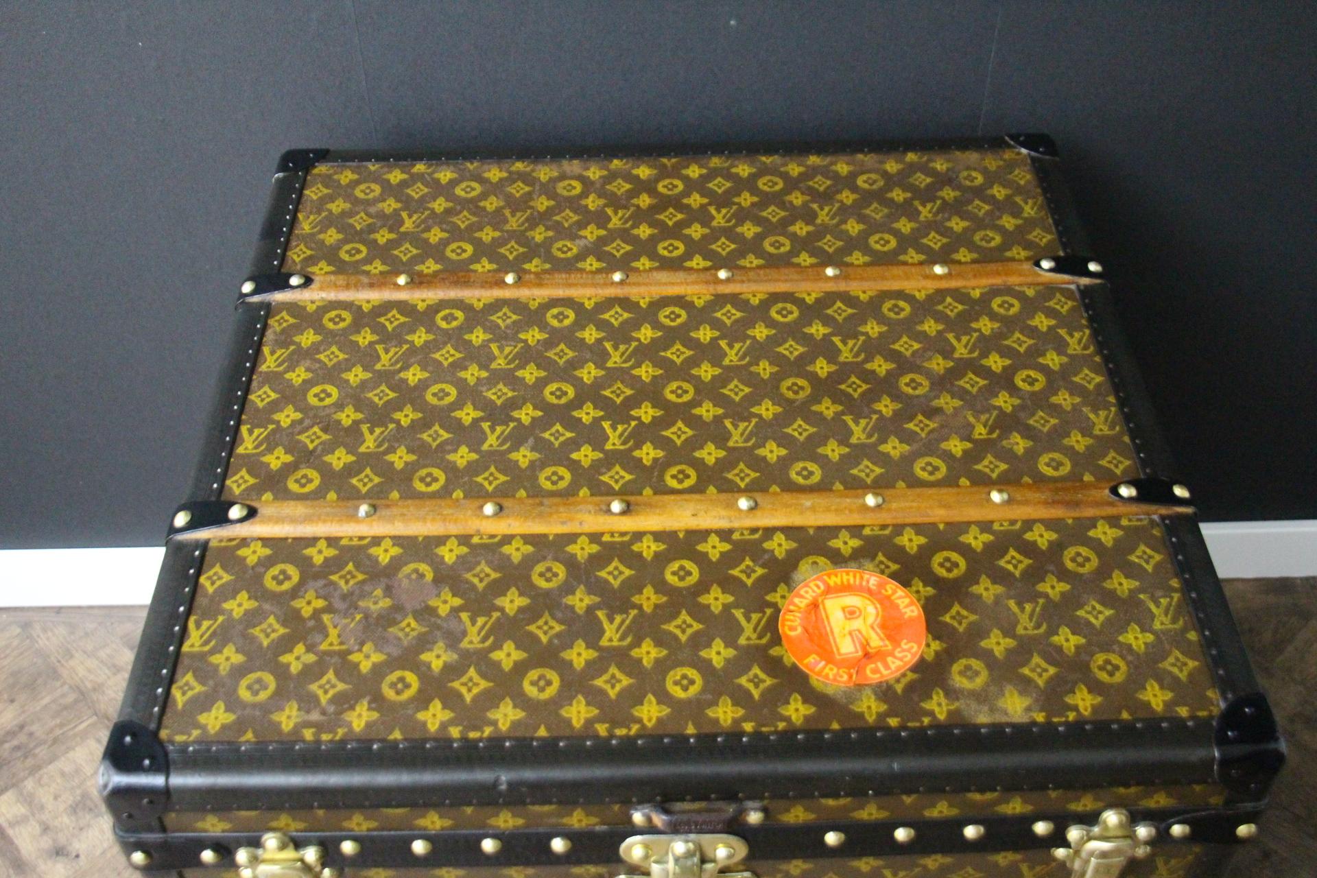 This beautiful and very rare Louis Vuitton trunk features hand painted stenciled monogram canvas, black color lozine trim, black steel side handles, stamped Louis Vuitton brass studs, lock and clasps. It also features hand painted yellow and and