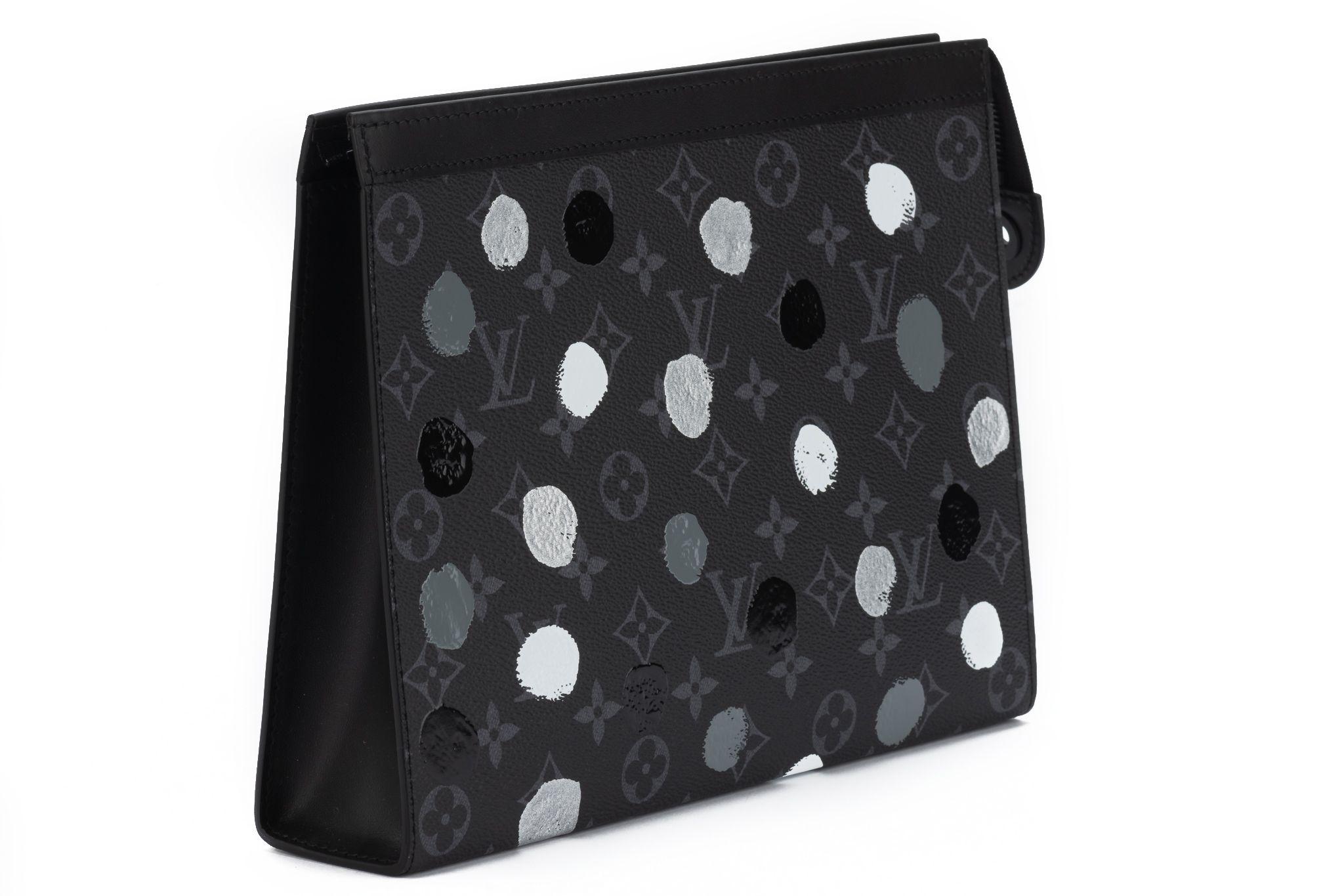 Louis Vuitton x Yayoi Kusama Pochette Voyage features a gray-scale interpretation of the artists hand-painted dots. Bag is brand new and comes with the box and dustcover.