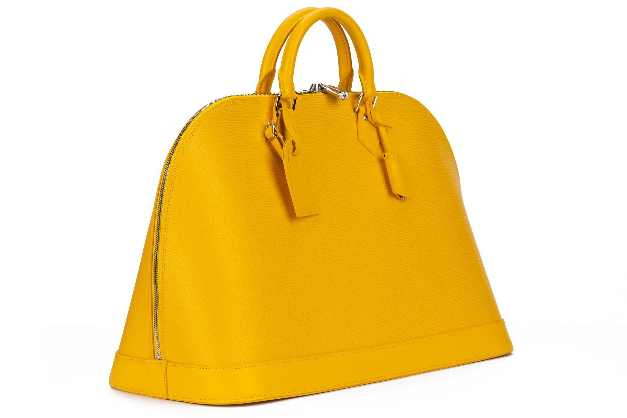 Louis Vuitton Alma Handbag yellow Epi Leather rare and collectible xxl size. The bag is in new condition, protective plastic still on the feet.The handles measure 3.5 inches. The bag comes with the original dustcover, clochette, tirette, lock and