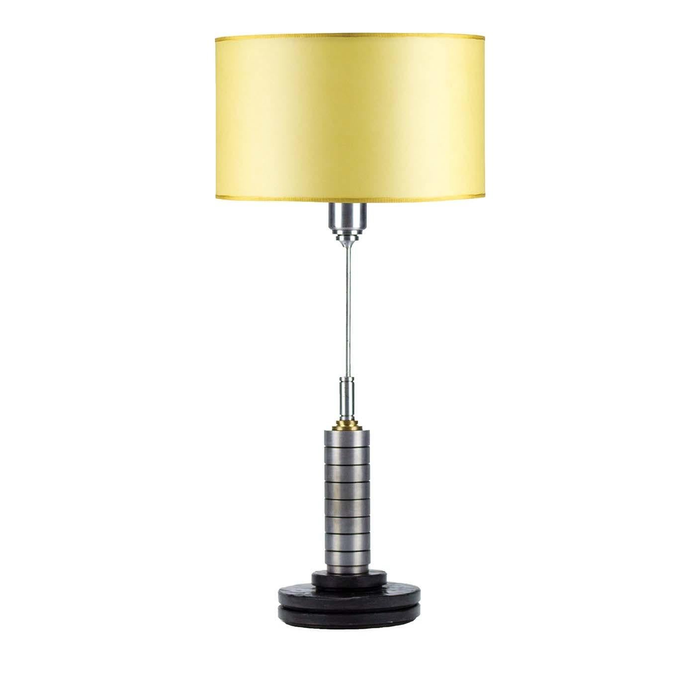 Simple and striking, the round Matrix marble base is the perfect support for the slender steel structure of this refined abat-jour. A decorative cylindrical element with a brass-colored top embellishes the lower part of the stem, while the top