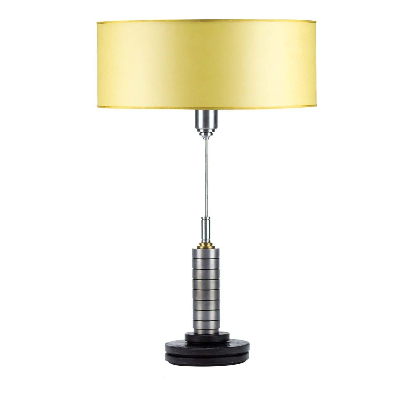 With its sleek and modern profile, this elegant table lamp will elevate the style of any interior, diffusing a perfect ambient light on a console in the entryway or on a side table in the living room. Supported by a polished round base of matrix